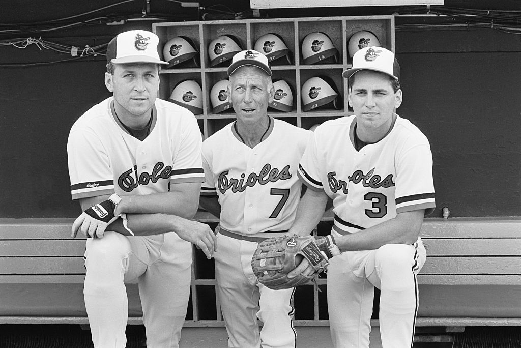 Cal Ripken Sr., center, is joined in the dugout by shortstop Cal Ripken Jr., left, and second baseman Billy Ripken. Jackson Holliday will become the first Oriole to wear No. 7 since Ripken Sr.