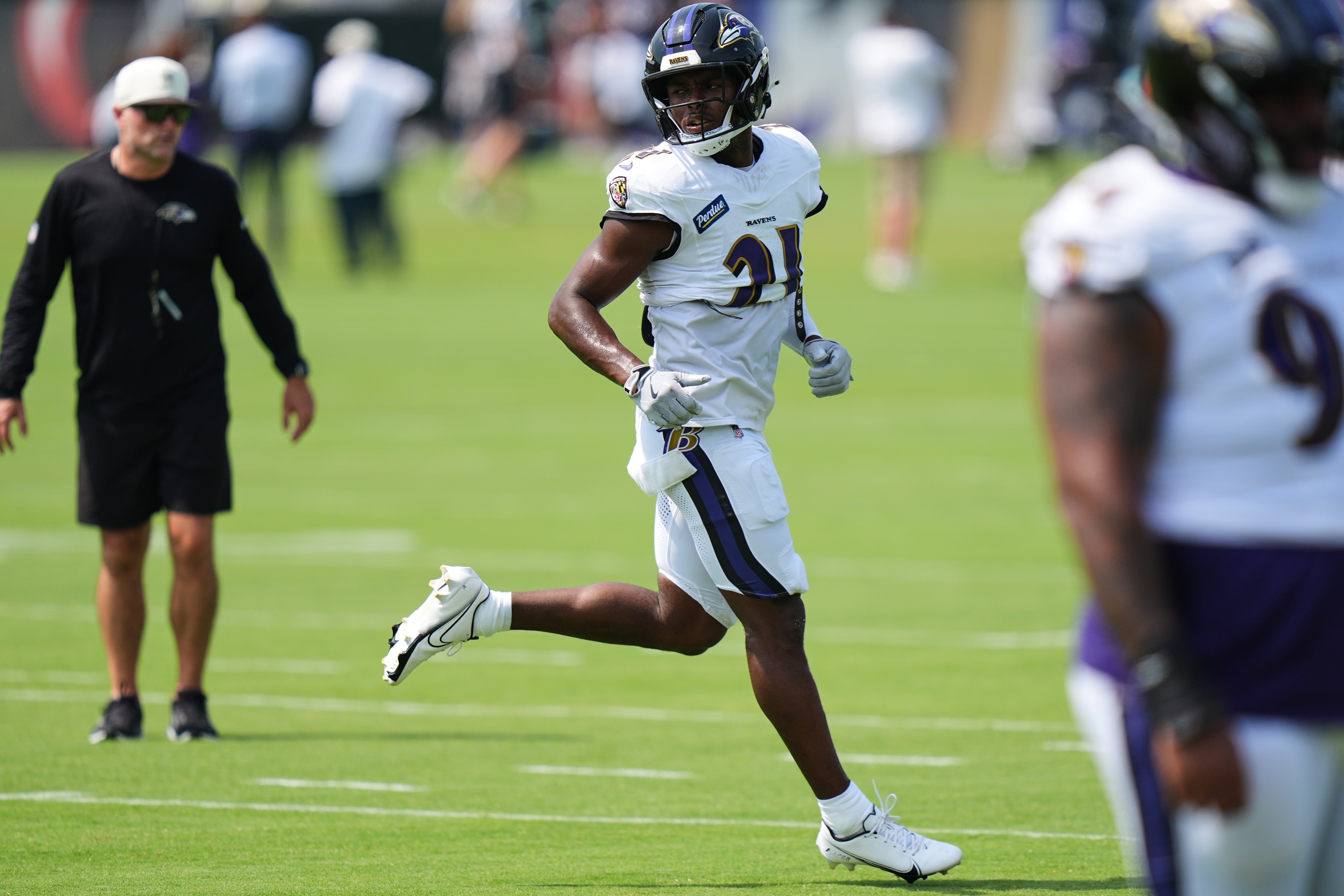 Baltimore Ravens safety Jaylinn Hawkins (21) works out during the team's NFL football training camp, Tuesday, Aug. 11, 2026, at the Under Armour Performance Center in Owings Mills, Md. (AP Photo/Stephanie Scarbrough)