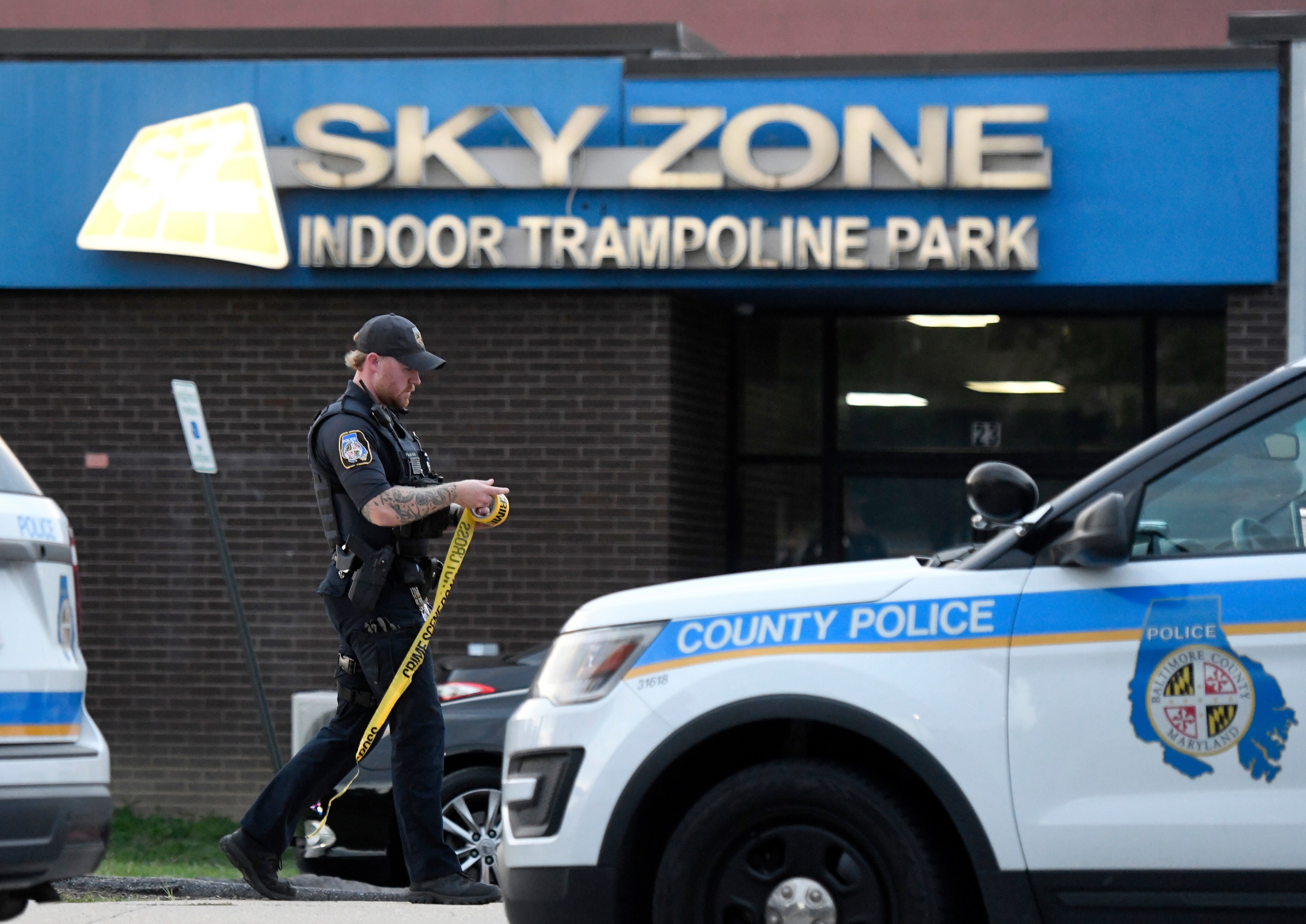 A Baltimore County police officer works outside a Sky Zone trampoline park after shots were fired, according to police, in Timonium, Saturday, Aug. 12, 2023.