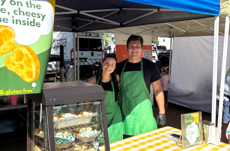 Thaina and Josh Ceribelli in front of their Fells Point Farmer's Market stall that they've run since August.