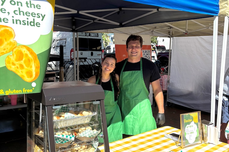 Thaina and Josh Ceribelli in front of their Fells Point Farmer's Market stall that they've run since August.