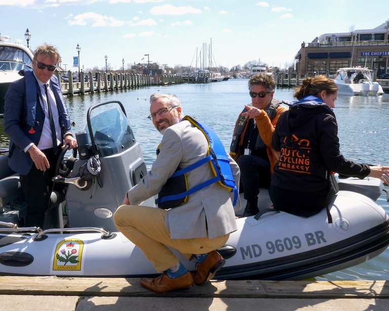 Alderman Rob Savidge holds the mayor's boat during a May 2024 tour of the Annapolis waterfront for a delegation of Dutch city officials.