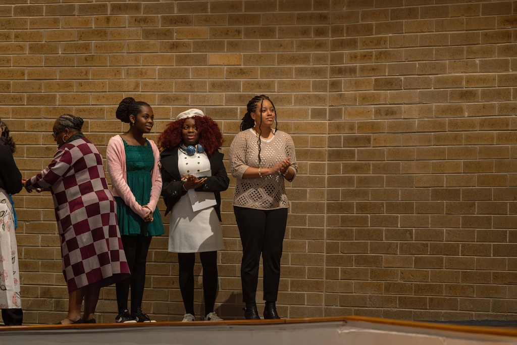 Kaliyah Fletcher, right, waits to cross the stage during the award ceremony for the Prince George's County Write-A-Book contest.