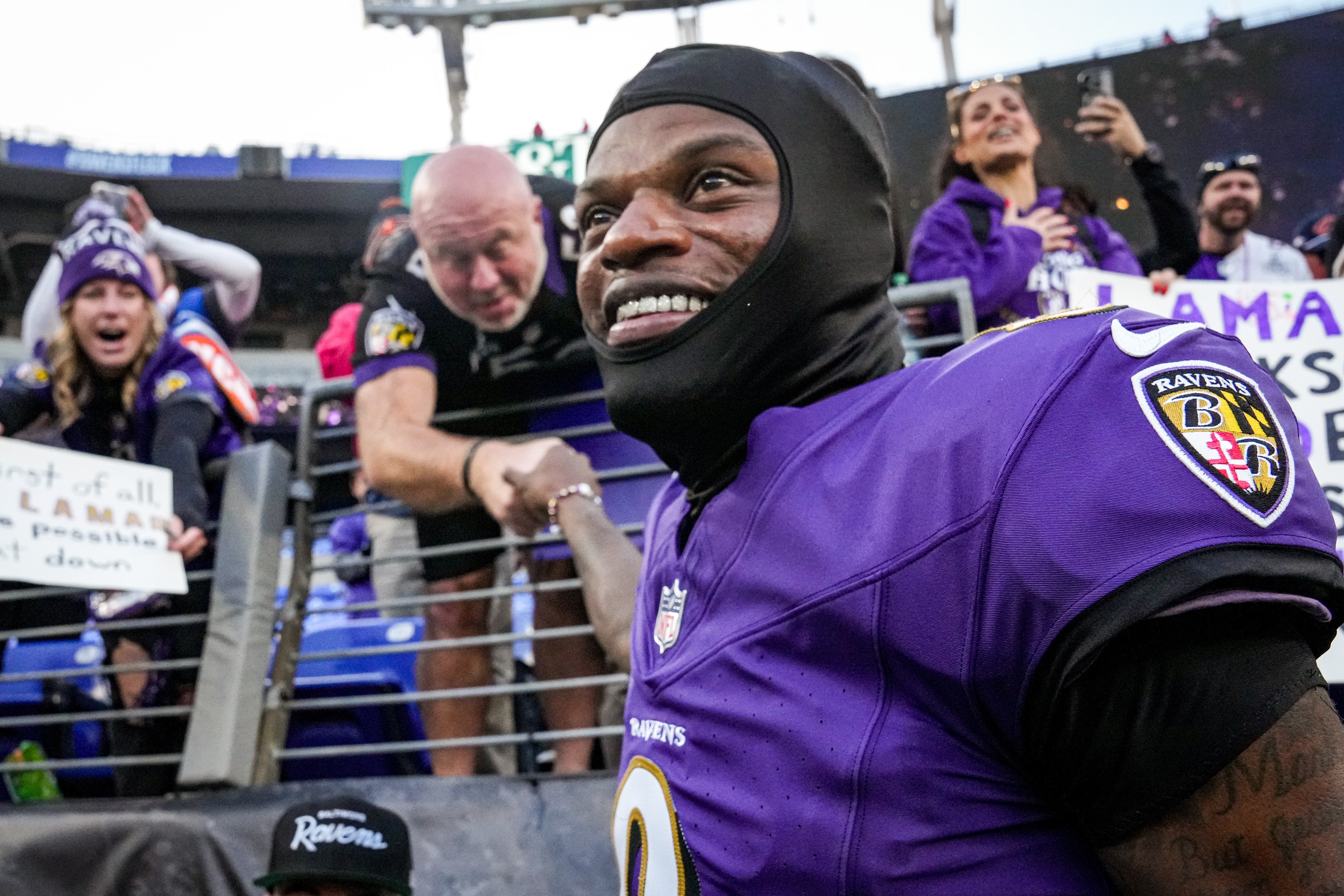 Ravens quarterback Lamar Jackson fist bumps a fan after Sunday’s win against the Denver Broncos.