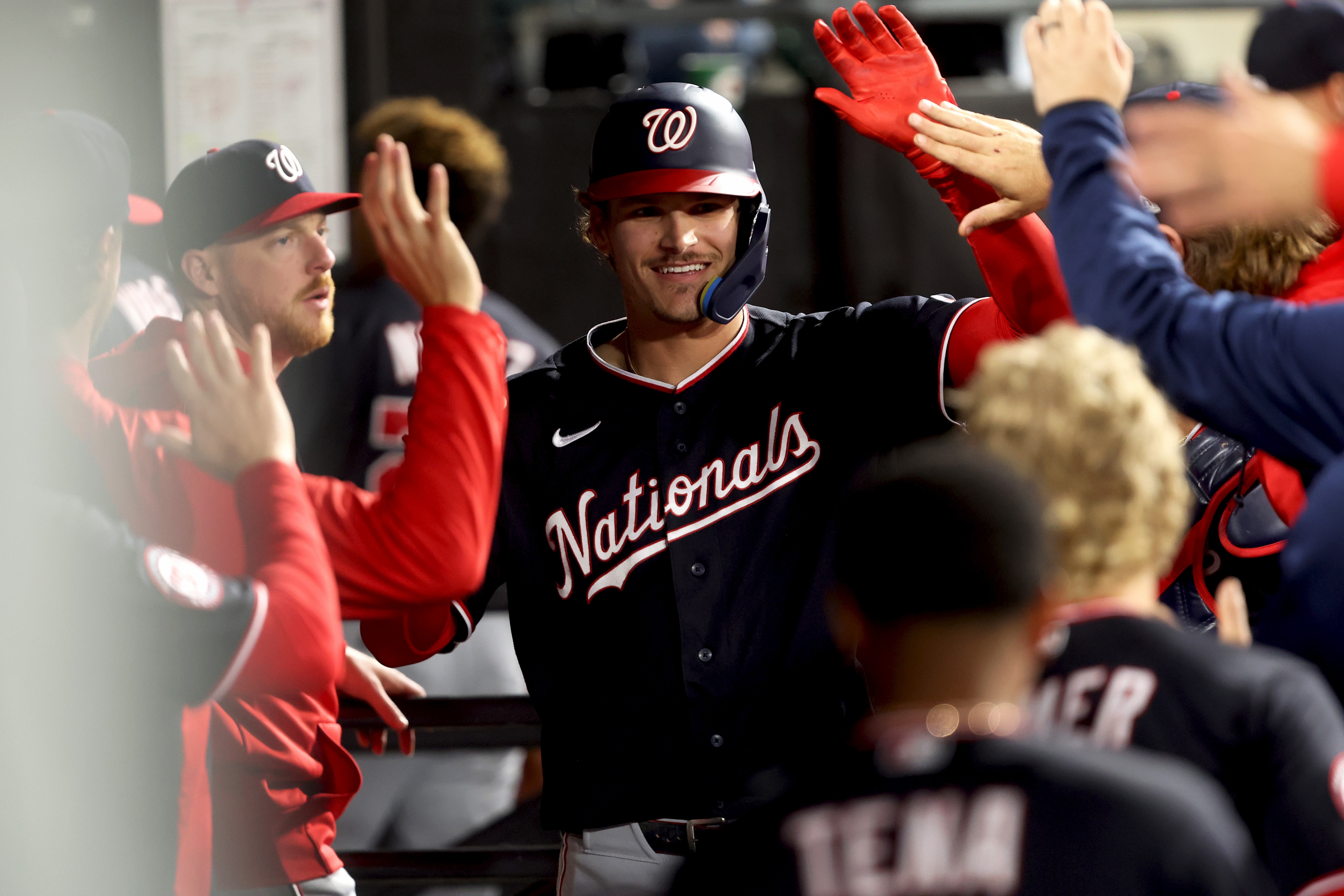 Brady House of the Nationals high-fives teammates after hitting a home run during the eighth inning Friday night.