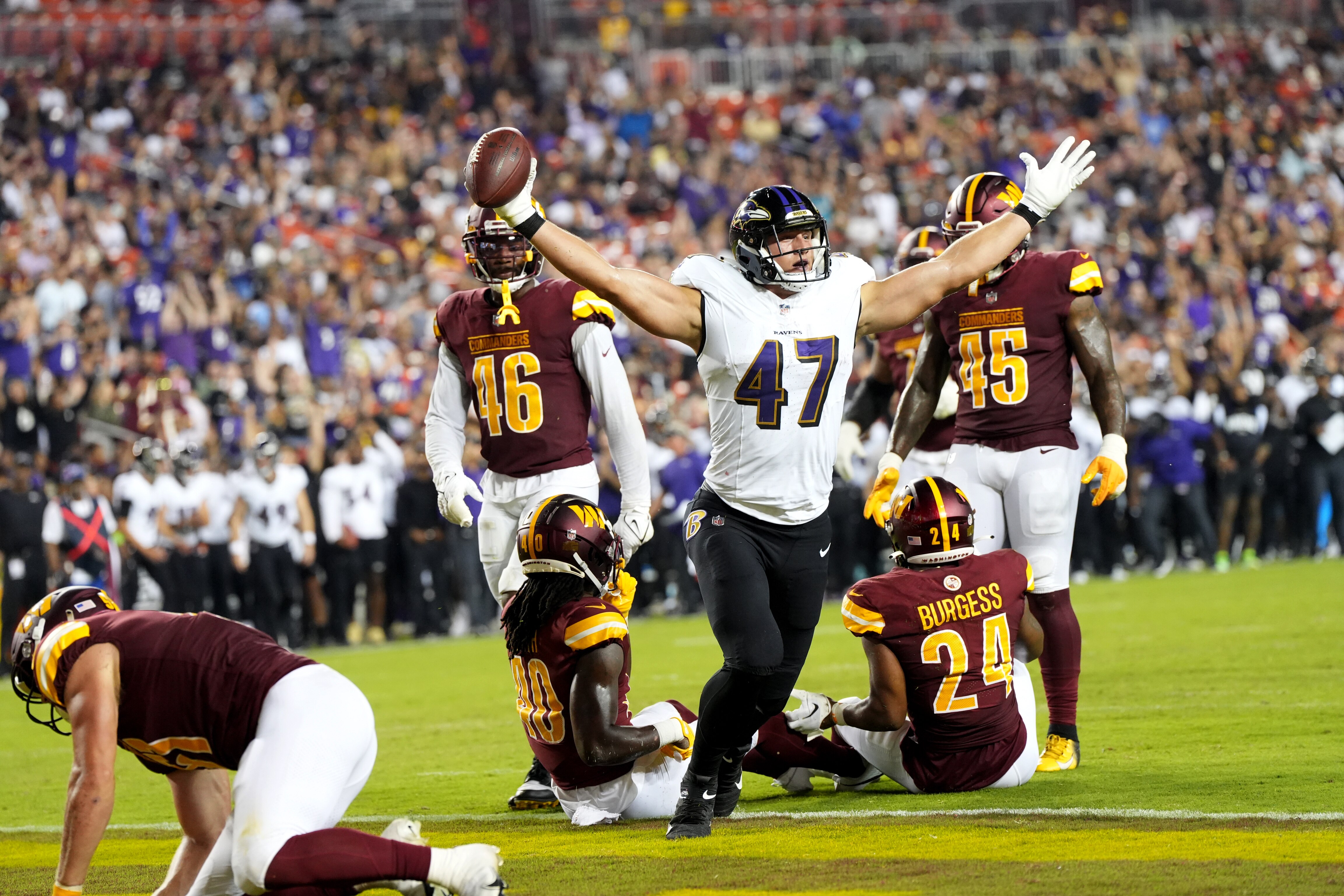 Baltimore Ravens tight end Travis Vokolek (47) catches a TD in the 3rd quarter during a preseason game against the Washington Commanders at FedEx Field on Monday, Aug. 21, 2023.