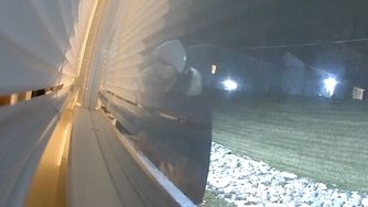 A still from Ring camera footage shows a man looking into the Chloe White's apartment in March.