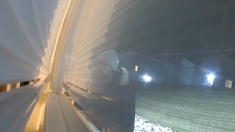 A still from Ring camera footage shows a man looking into the Chloe White's apartment in March.