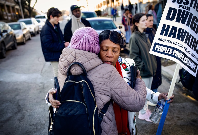 Lorraine Hawkins hugs a supporter during a rally at the 2800 block of Pelham Avenue in Baltimore's Belair-Edison neighborhood, where her nephew, Dwight Hawkins, was shot and killed by Baltimore Police earlier this week.