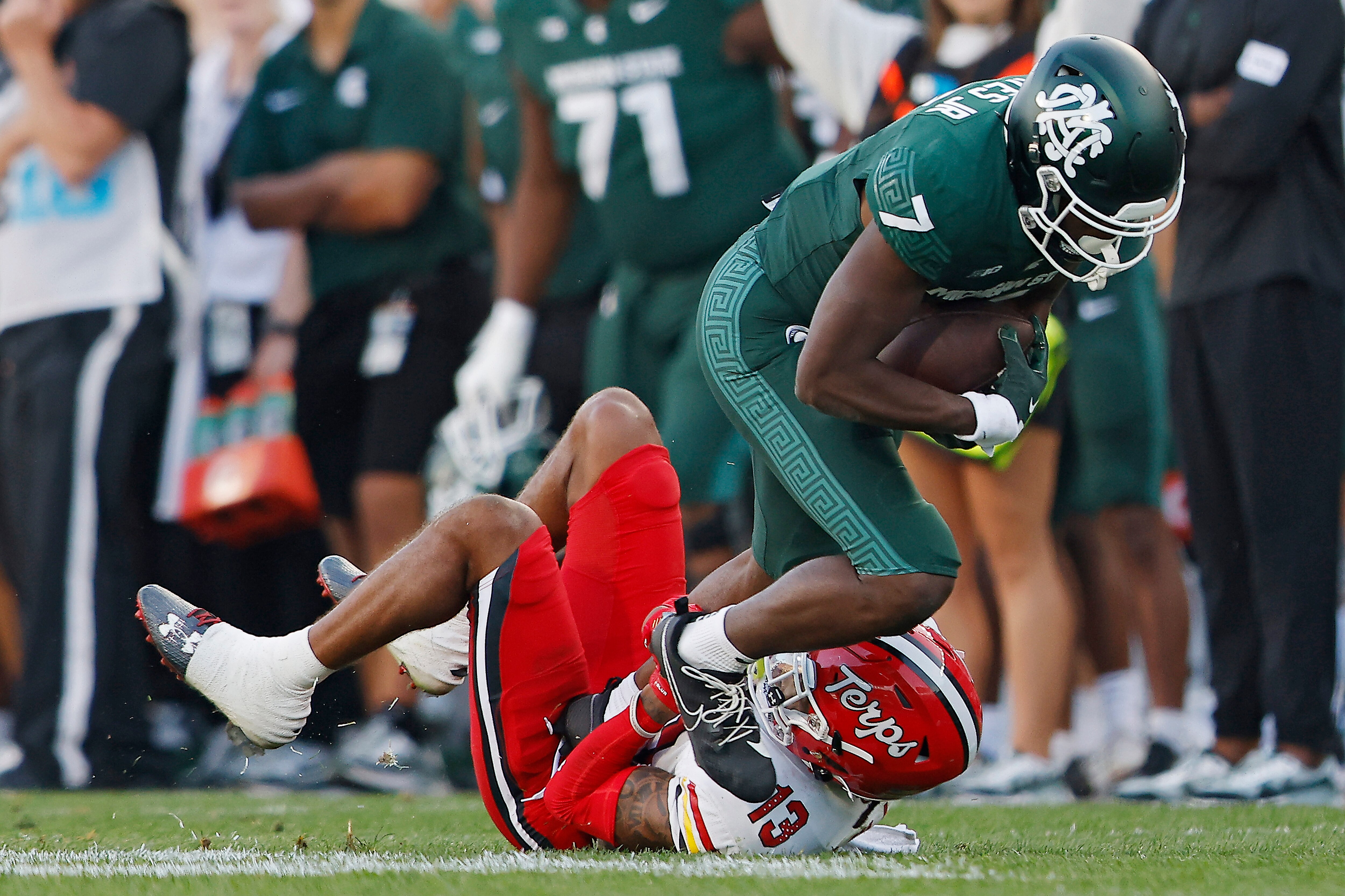 Glendon Miller #13 of the Maryland Terrapins tackles Antonio Gates Jr. of the Michigan State Spartans in the fourth quarter of a game at Spartan Stadium on September 23, 2023 in East Lansing, Michigan.