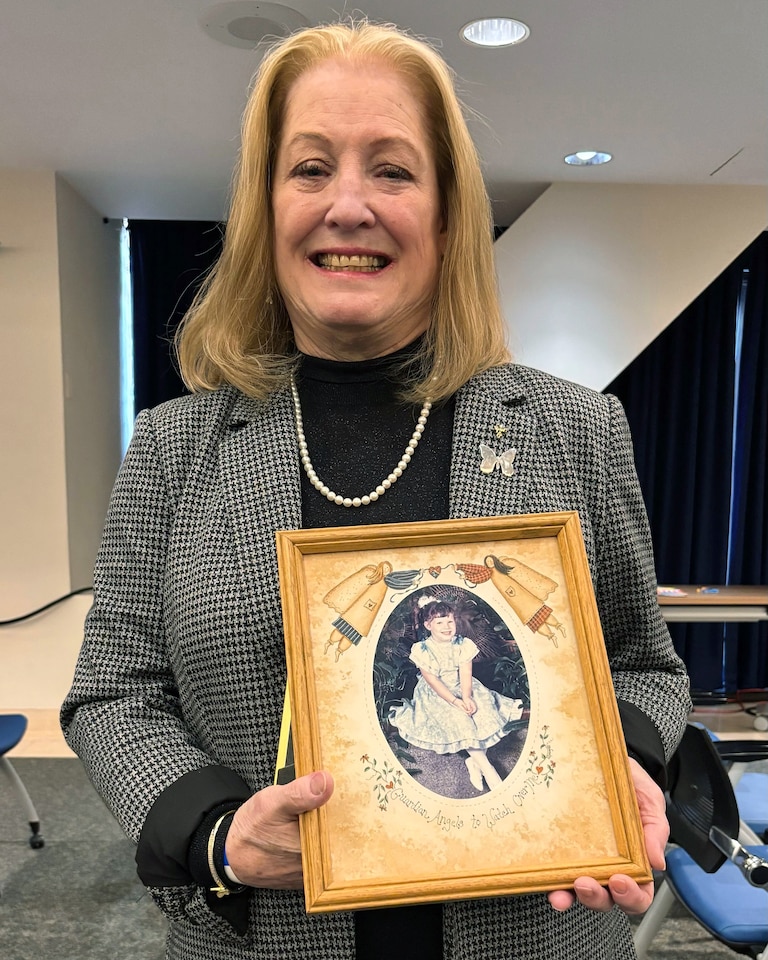 Tuesday, December 16, 2025 - At the Federal Health and Human Services press conference in Washington, DC, Teryn Suhr, founder of the MLD Foundation, holds a photo of her daughter, Darcee, who died exactly 30 years ago today of MLD. Suhr’s older daughter, Lindy, 45, is living with a less severe form of the condition.