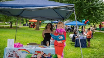 Imagination Library of Montgomery County, Maryland, Program Director Carol da Silva poses with a life-size cardboard cutout of Dolly Parton while promoting the program at a recent Father’s Day event in Wheaton.