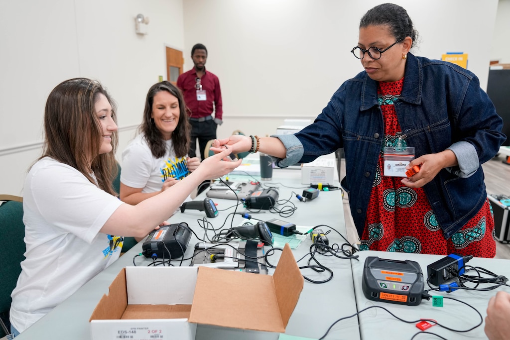 Instructor Kishanna Harley, right, helps Amanda Prince, left, and Misti McKeehen set up polling equipment during a training session for election judges for the upcoming Maryland Primary Election in Baltimore, Md. on Saturday, May 30, 2026.