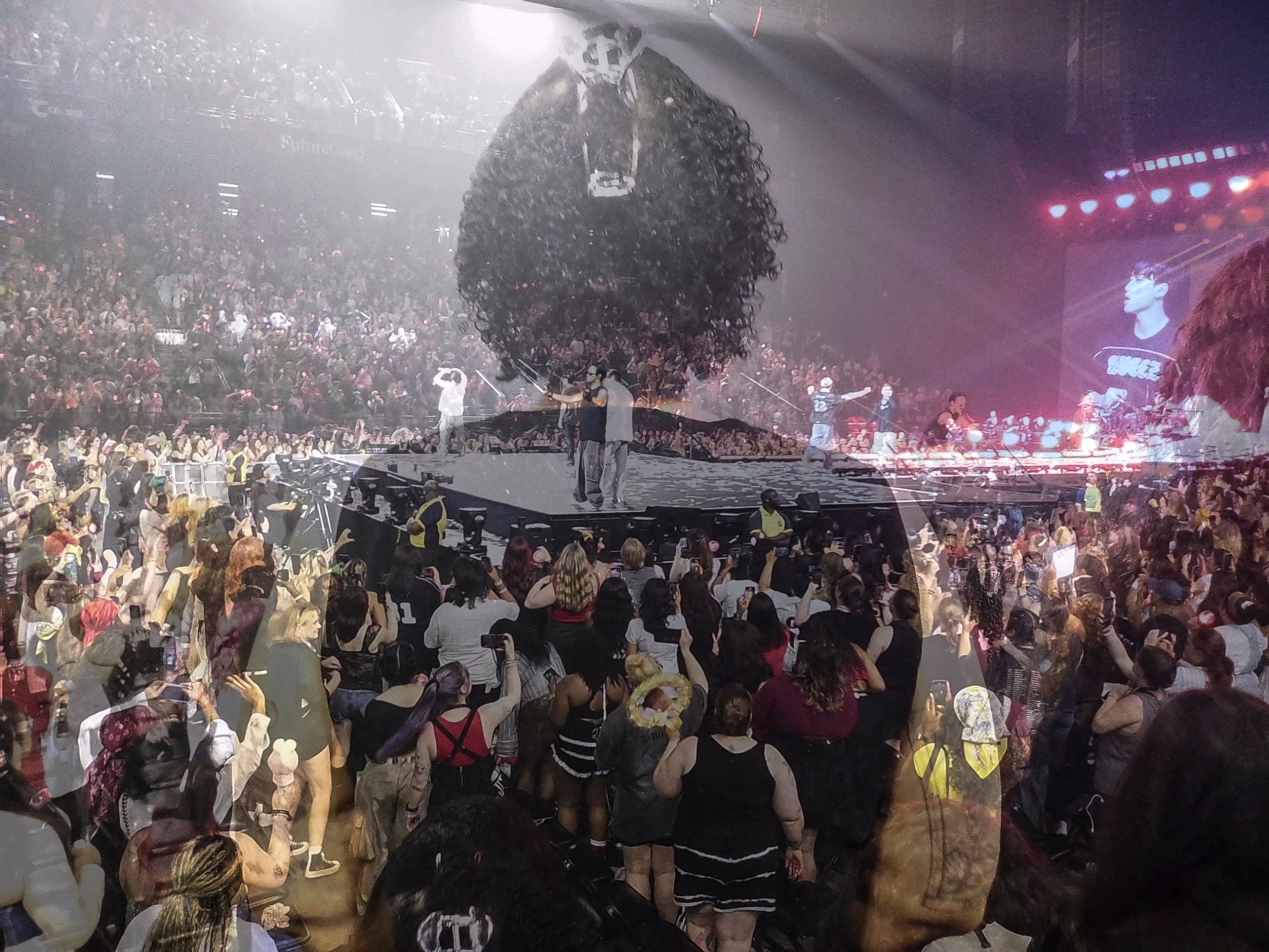 A double exposure photograph as fans watch ATEEZ perform at CFG Bank Arena.