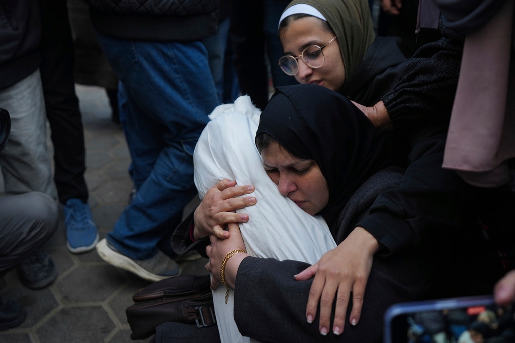 Hanan Shaqoura embraces the body of her son, Mohammad, 7, who was killed in the Israeli bombardment of the Gaza Strip, during his funeral in Deir al-Balah, Wednesday, Jan. 15, 2025.
