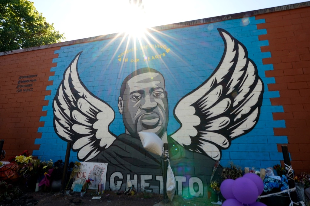 The sun shines above a mural honoring George Floyd in Houston's Third Ward on Sunday, June 7, 2020.