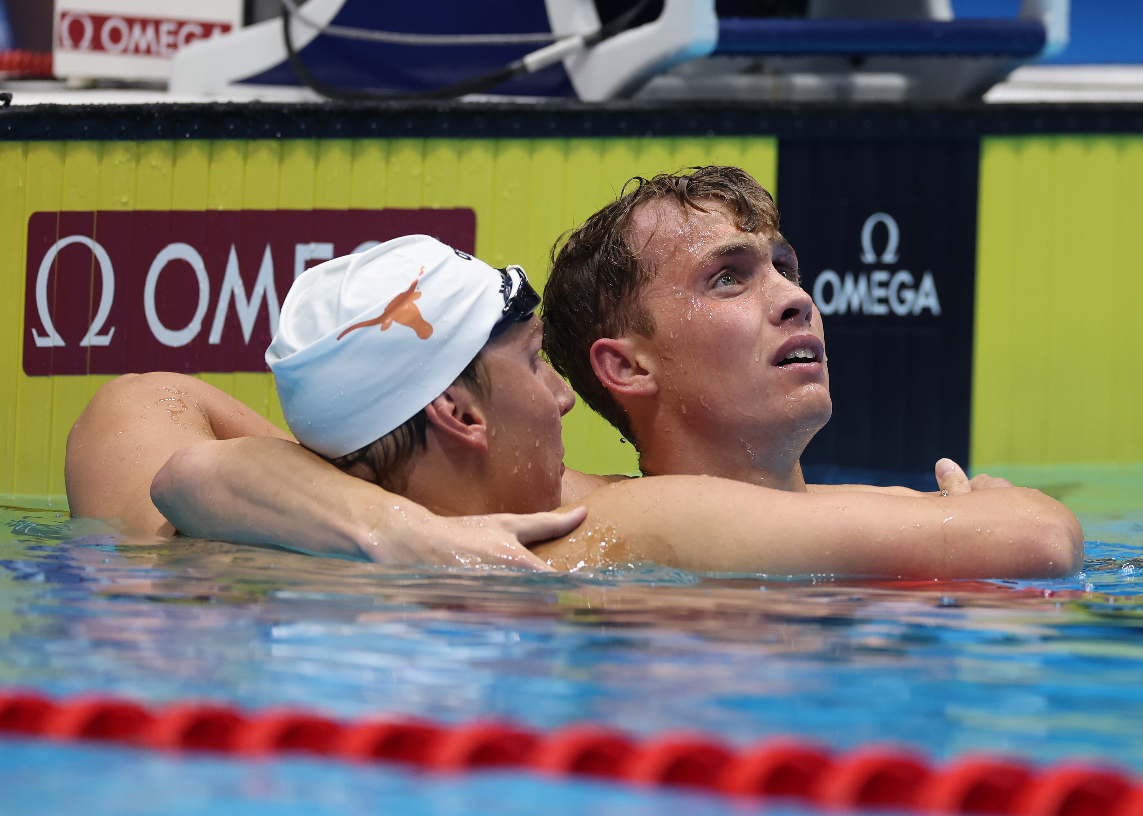 Chase Kalisz (left) and Carson Foster embrace after Foster's win in the 400-meter individual medley Sunday night at the U.S. Olympic Trials.