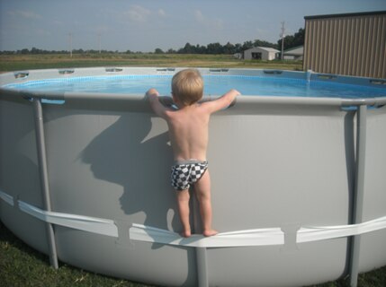 In this undated image provided by the CPSC, a child uses the compression strap to stand on the above-ground pool.