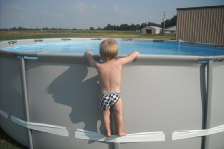 In this undated image provided by the CPSC, a child uses the compression strap to stand on the above-ground pool.