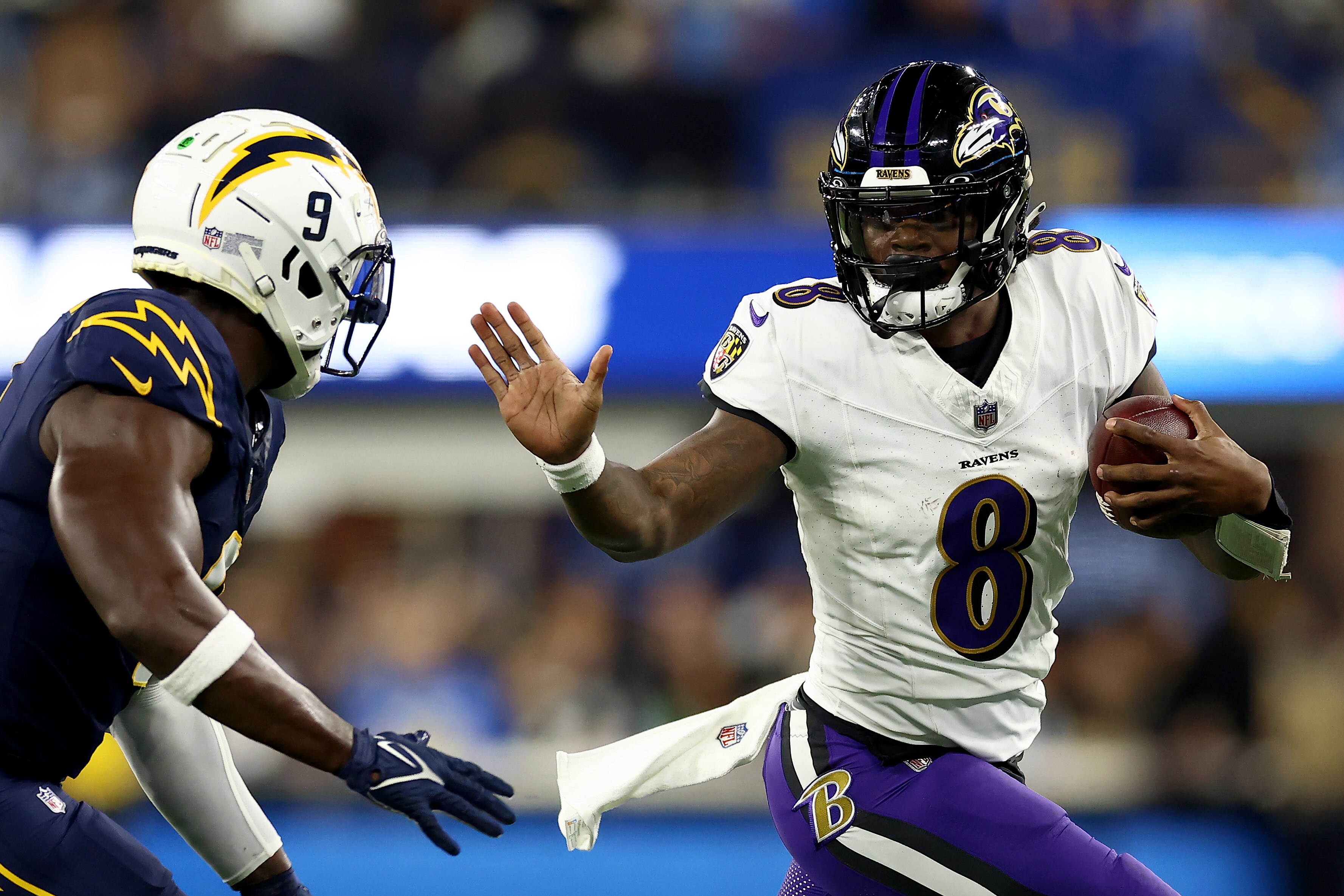 Lamar Jackson attempts to elude Kenneth Murray Jr. of the Los Angeles Chargers during the second quarter of the game Nov. 26.
