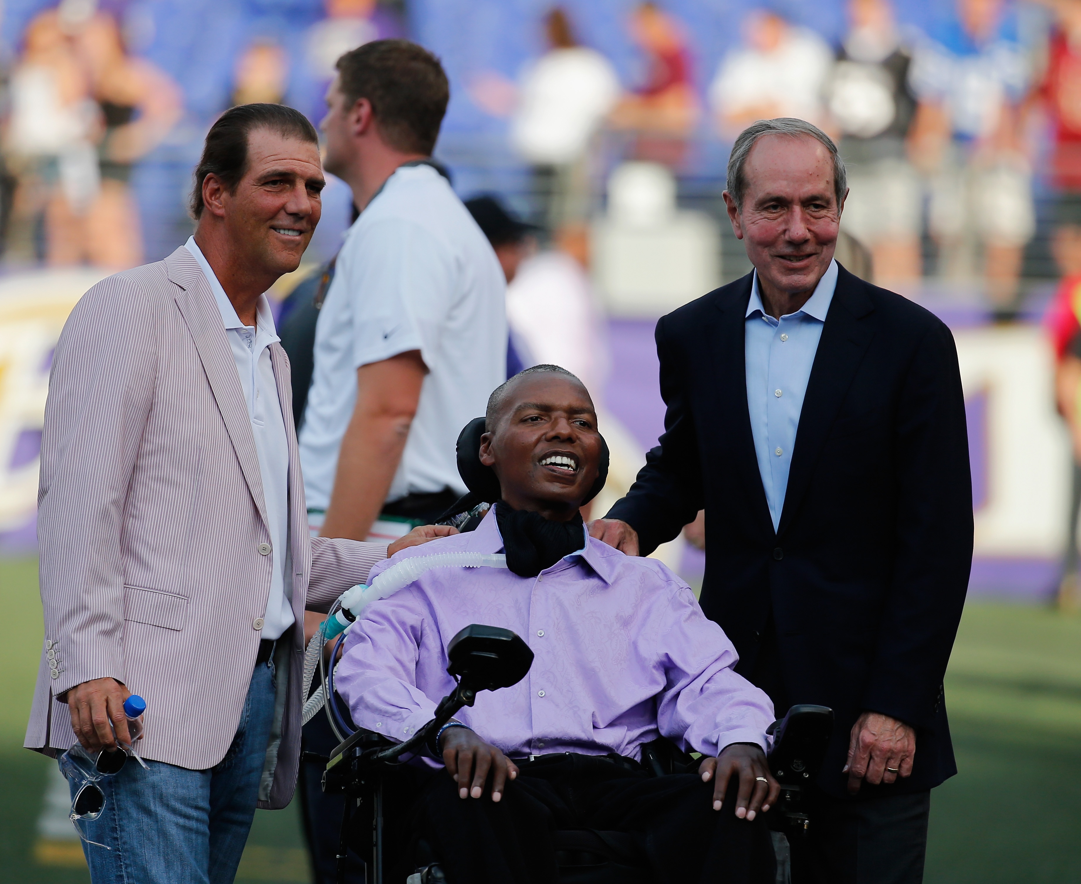Former Ravens linebacker O.J. Brigance, with team owner Steve Bisciotti and President Dick Cass in 2015, has lived with ALS for 16 years, far longer than is expected with the disease.