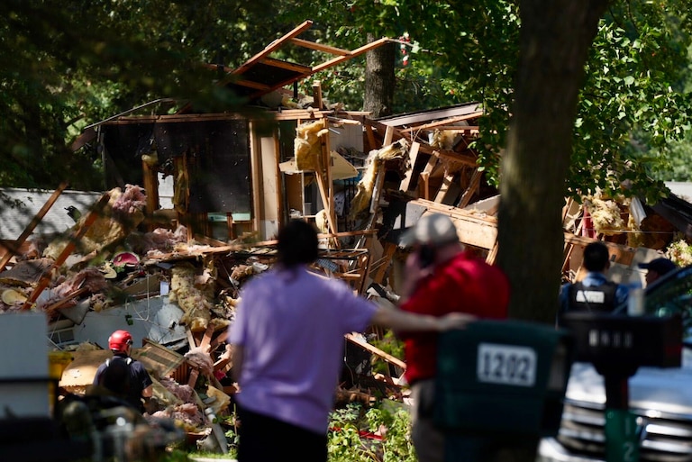 WEDNESDAY, AUGUST 19, 2026 - Neighbors look at the remnants of a house following a fatal home explosion next door, outside Annapolis on Wednesday