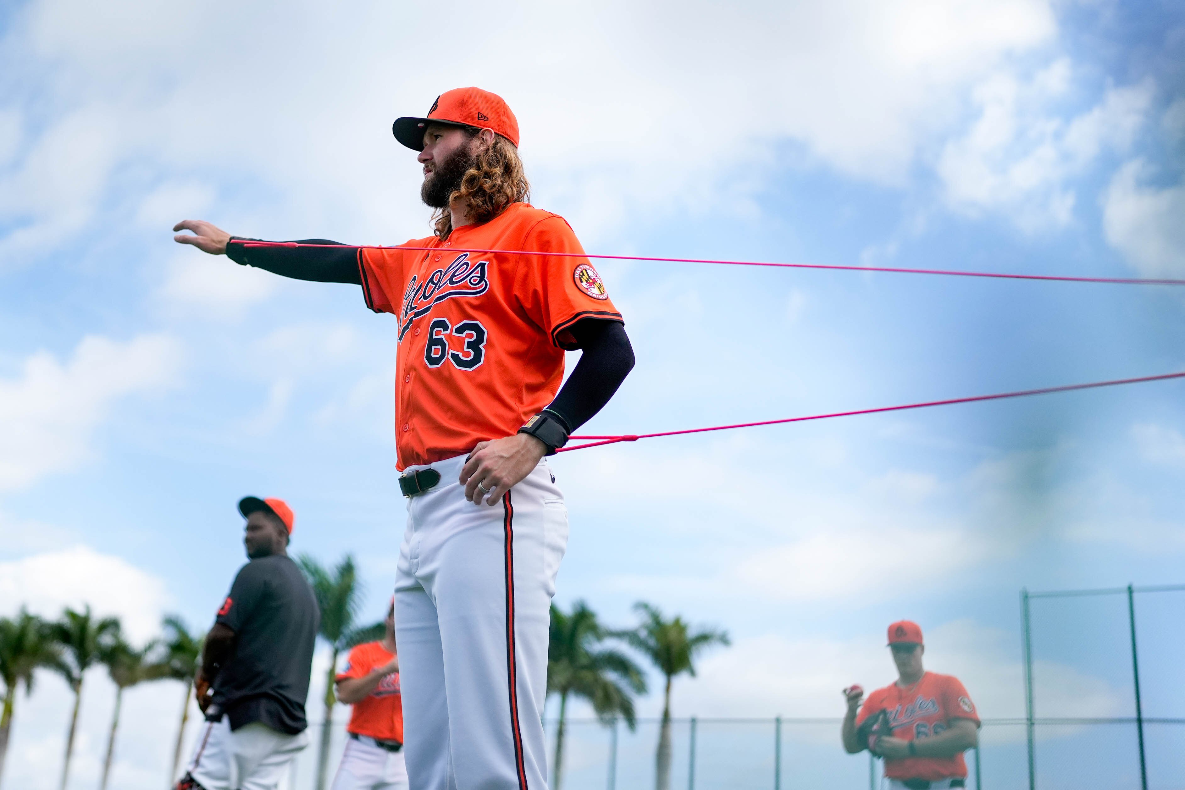 Brandon Young warms up with resistance bands during spring training in Florida.