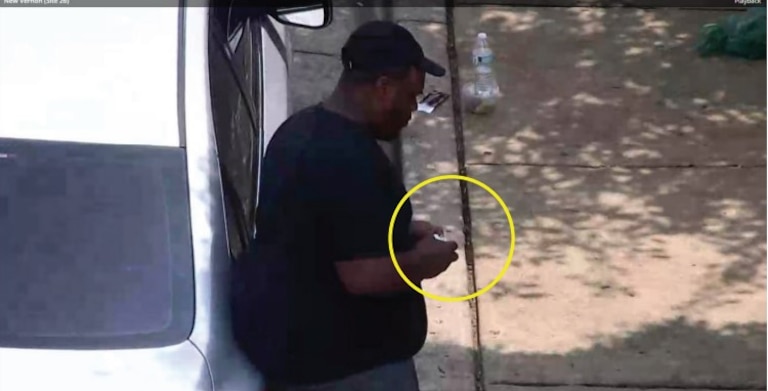 A man the FBI identified as Sheldon Wells holds suspected illegal drugs on Aug. 29, 2024, an image captured by a pole-mounted video camera.