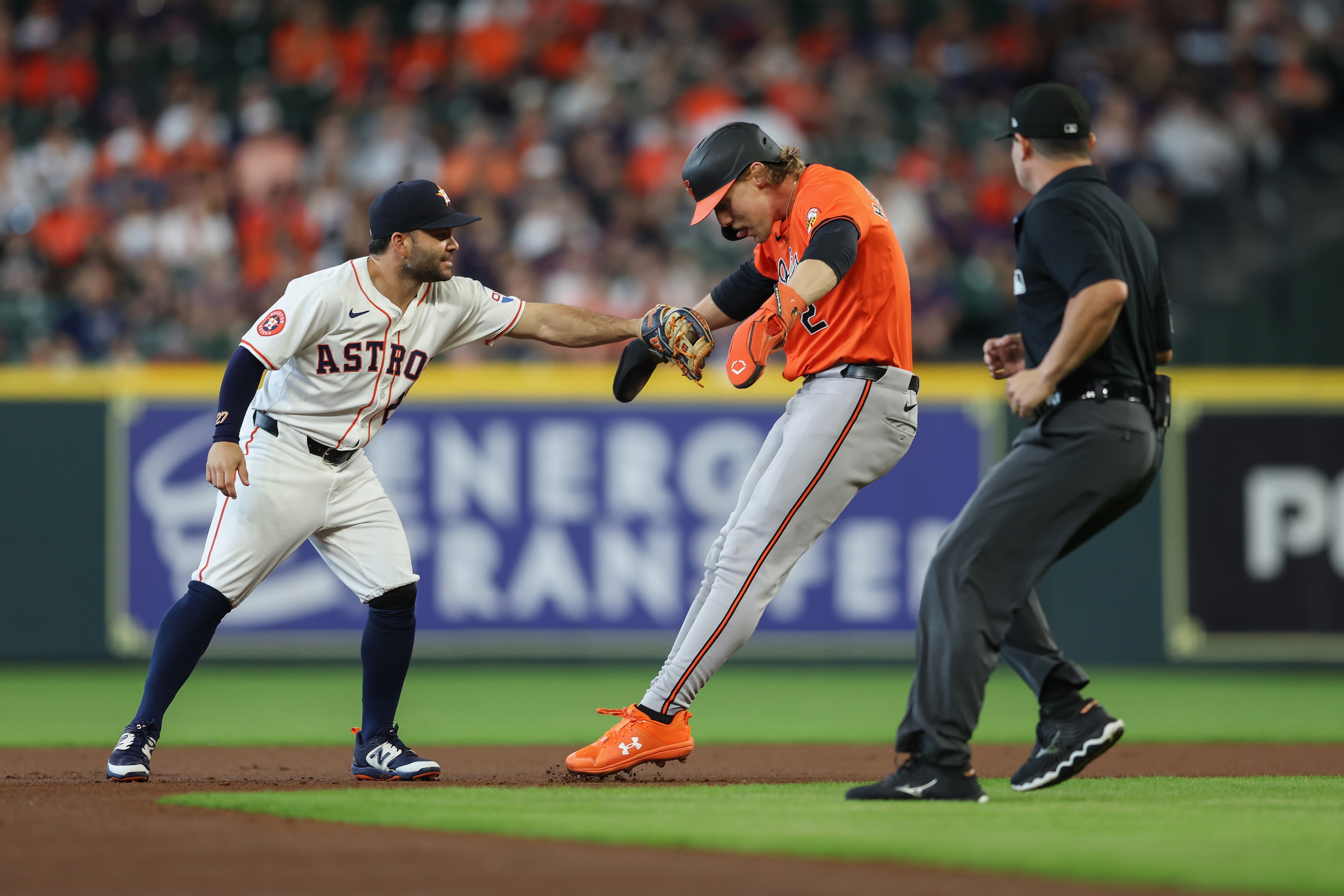 Astros second baseman Jose Altuve tags out Orioles shortstop Gunnar Henderson on an attempted stolen base in the first inning.