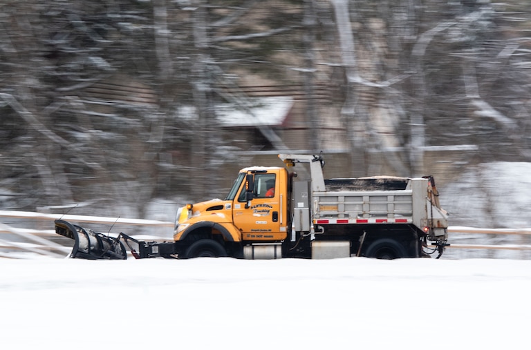 A snowplow clears snow on Snowden River Pkwy in Columbia, MD on January 6th, 2025.