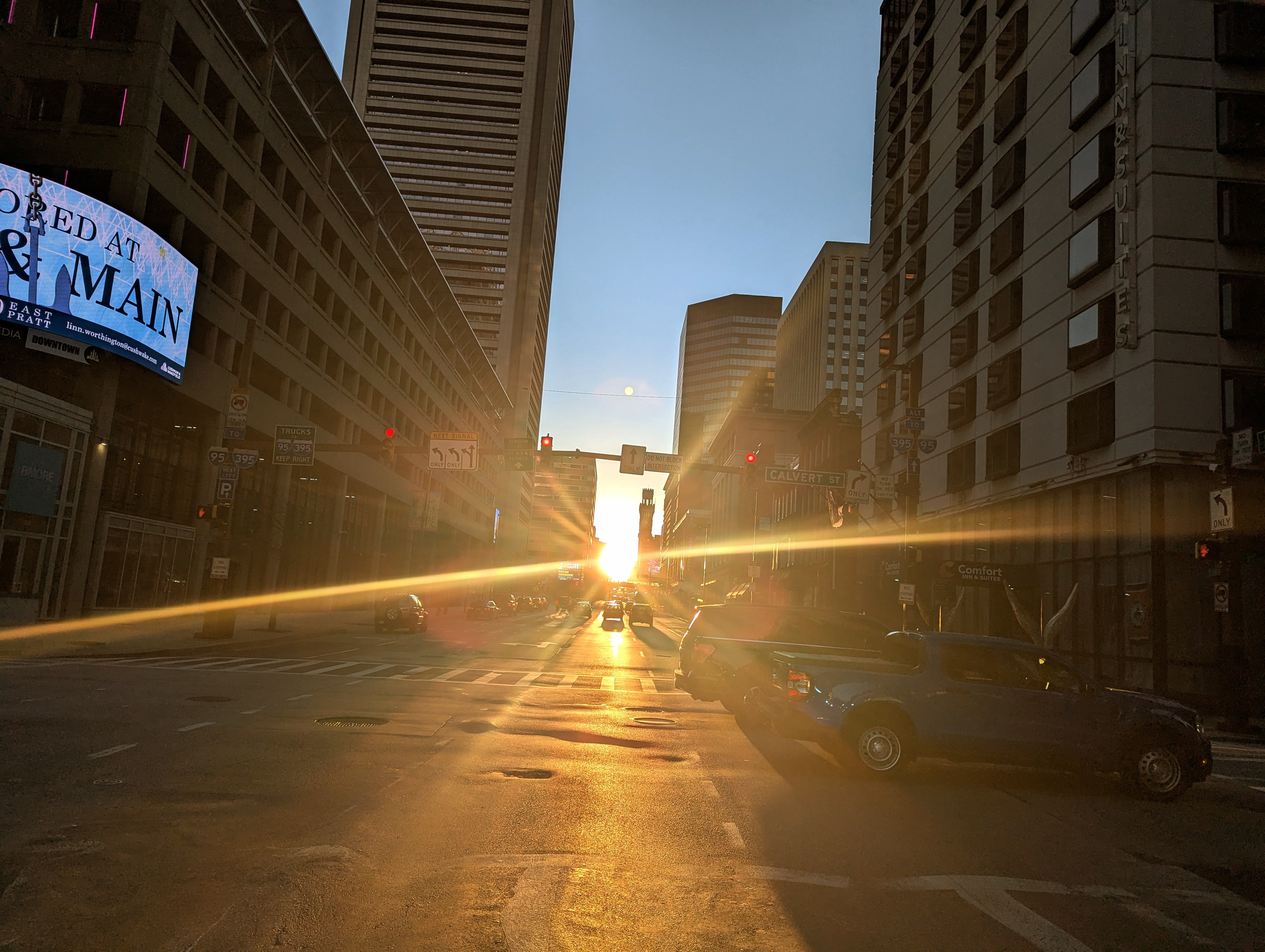 Sunset lines up with East Lombard Street at Calvert in Baltimore, MD on March 18, 2025, less than two days before the spring equinox.