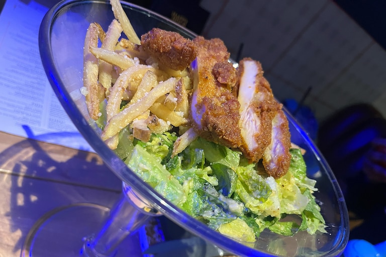 The Worthington’s “Girl Dinner” comes in a 48-ounce martini glass with Caesar salad and fries. Protein costs a few extra bucks.