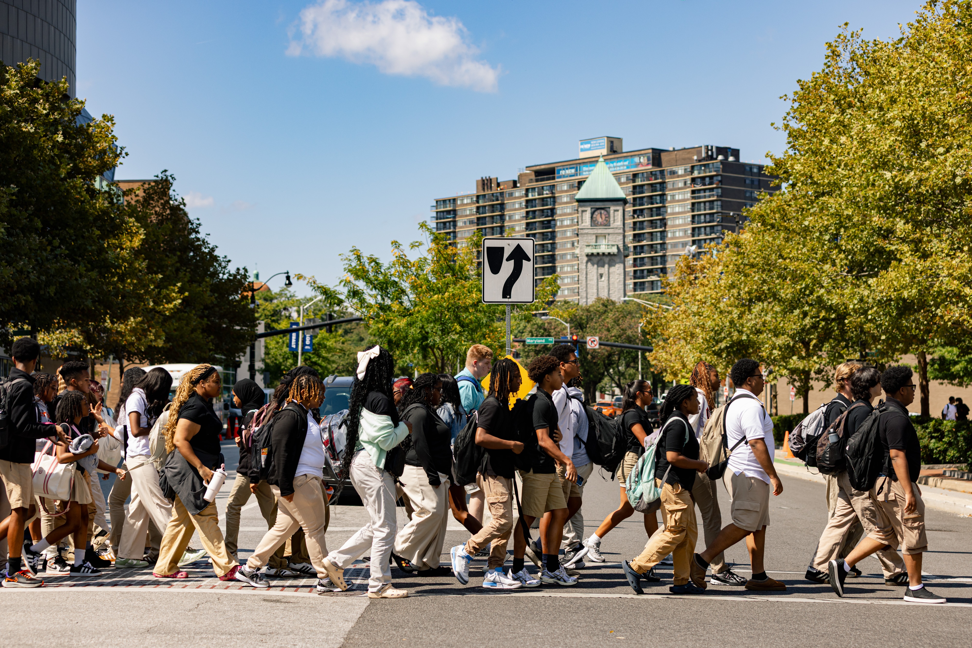 Baltimore City College High School students cross Mt. Royal Avenue outside of the University of Baltimore, where the students will be studying throughout a planned three-year renovation of their home campus, in Baltimore, MD on Thursday, Sept. 4, 2025.