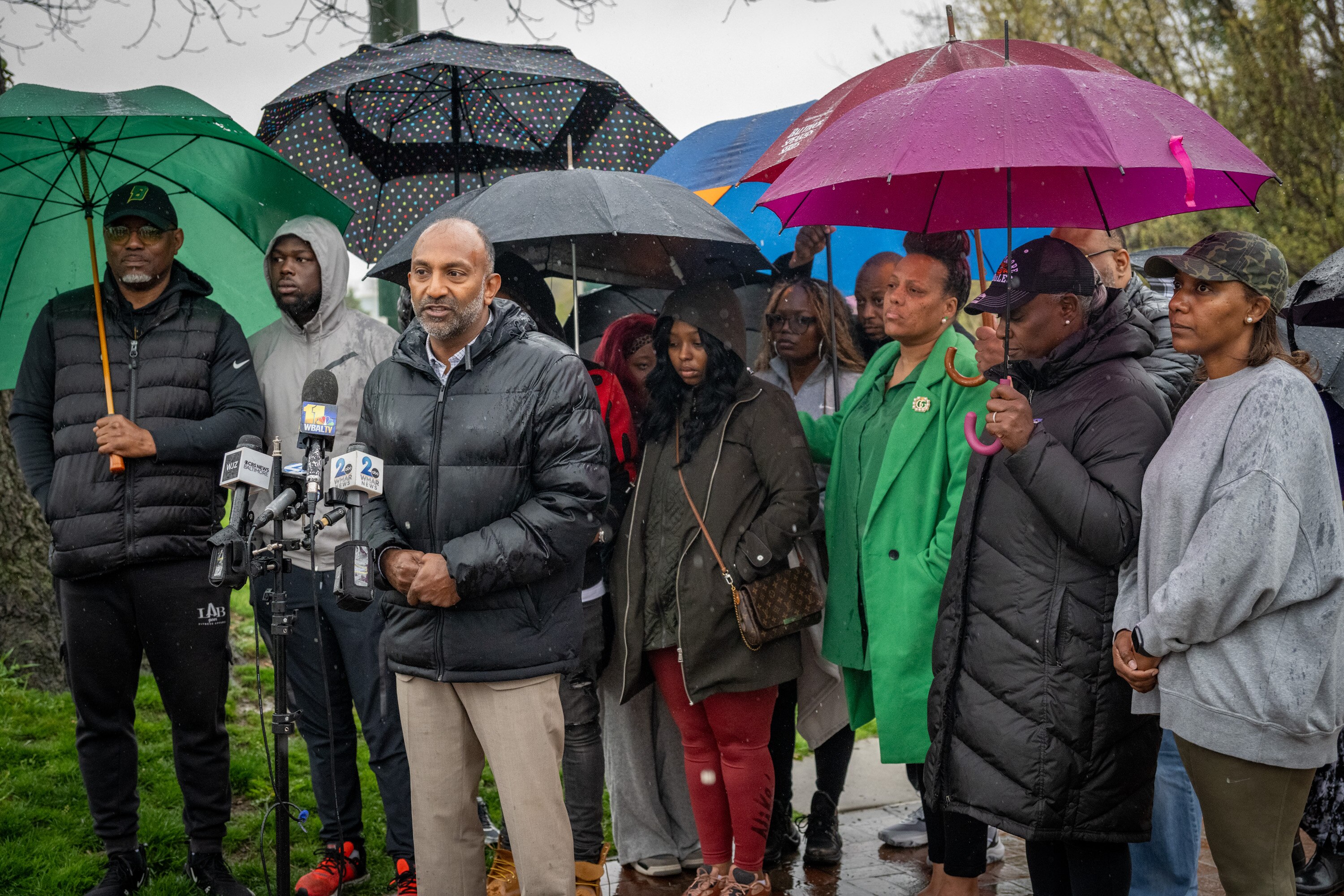 Attorney Thiru Vignarajah, center, stands with the family of Bailee Brooks, one of the two girls who died in a car accident almost a week ago.