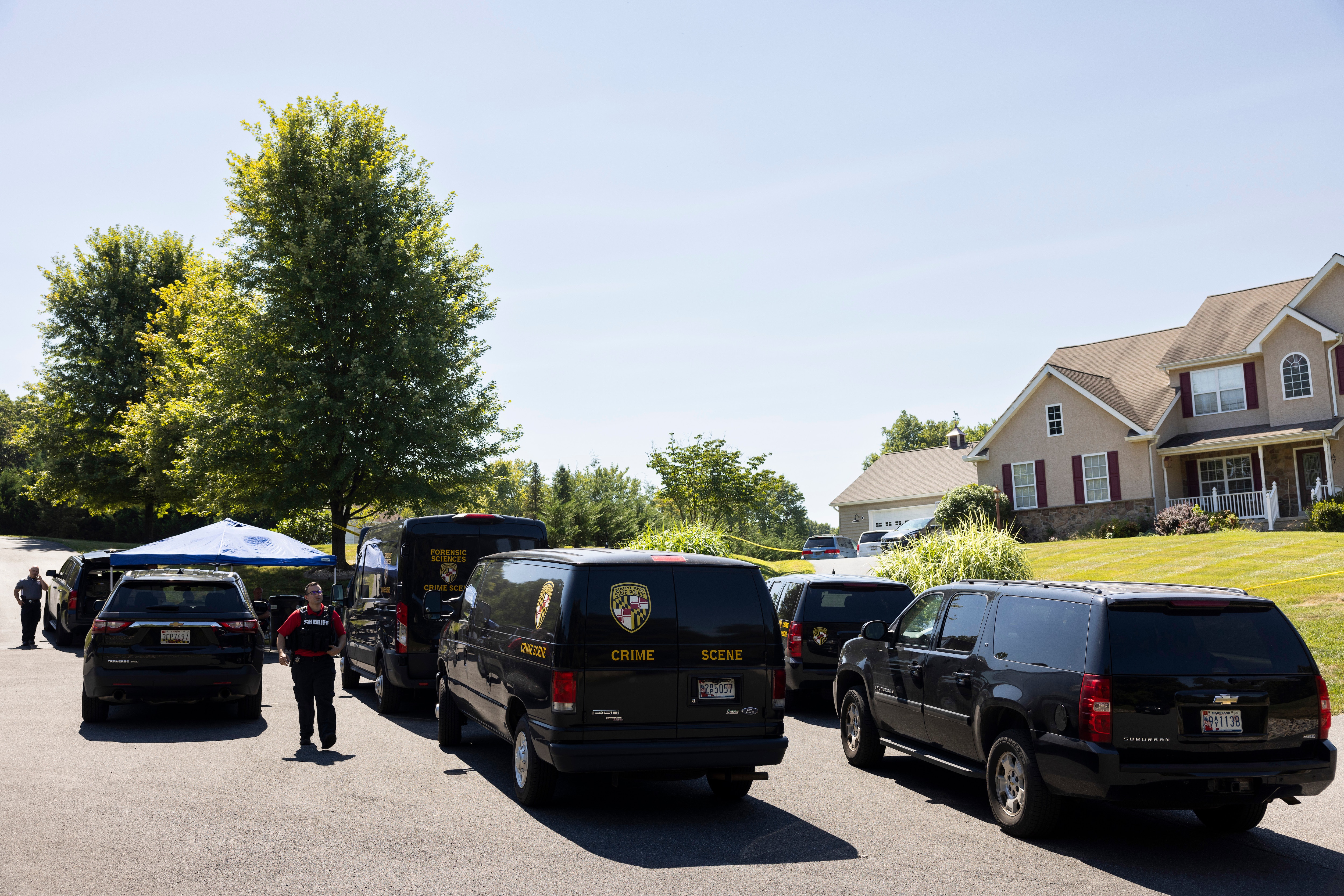 Law enforcement gather at the scene Friday, Sept. 9, 2022, in Elk Mills, Md., about 60 miles (97 km) northeast of Baltimore. Five people were found dead inside a home in northeastern Maryland on Friday after deputies were called to investigate a report of a shooting, authorities said.