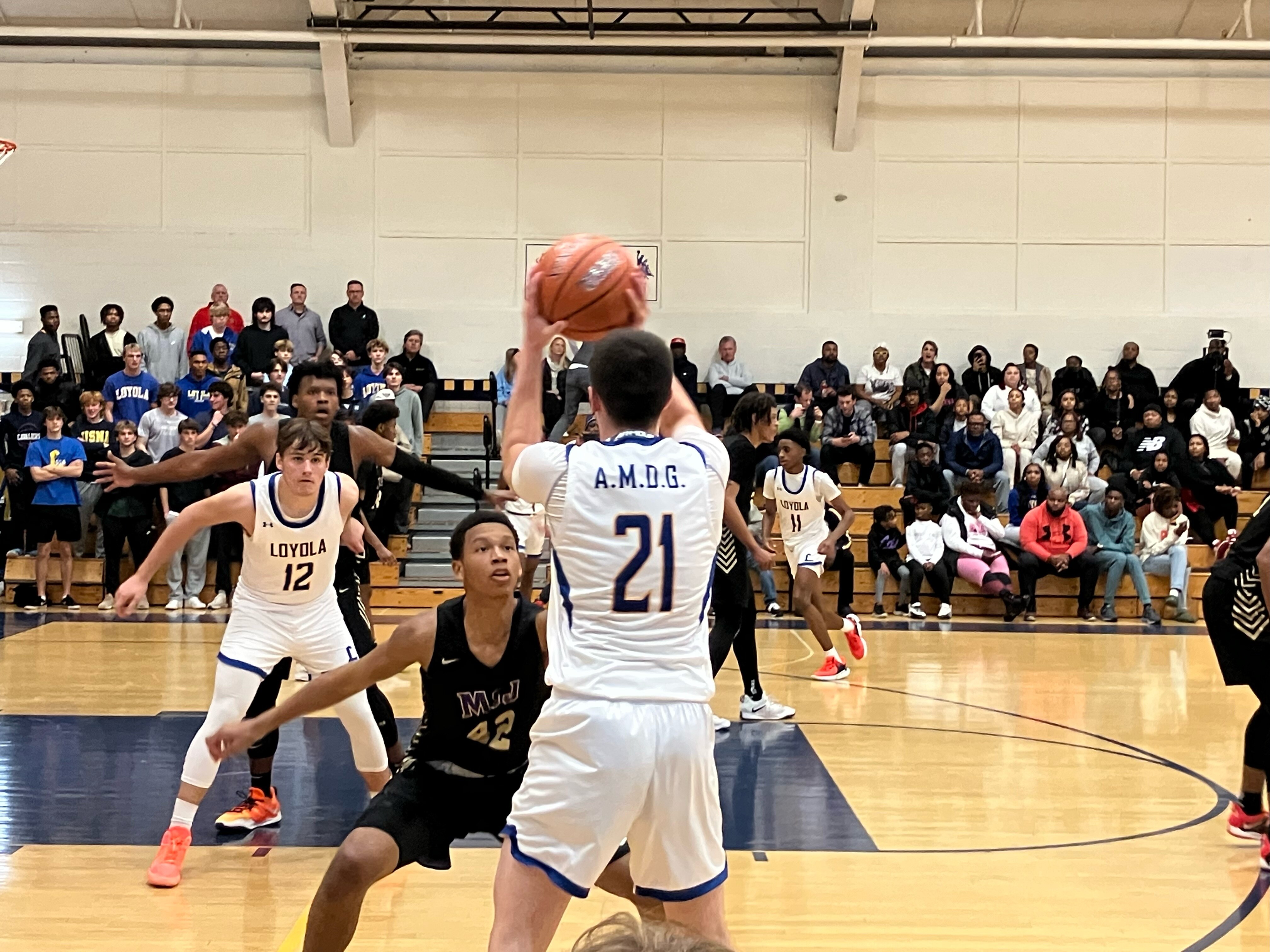 Loyola Blakefield senior guard Ryder Drew attempts to inbound the ball to sophomore Sam Navarre as Mount St. Joseph senior Brashshawn Galloway, foreground, and Amani Hansberry provide defensive pressure.