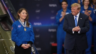 President Donald Trump applauds during a Congressional Space Medal of Honor ceremony at NASA's Johnson Space Center, Friday, Aug. 28, 2026, in Houston, after putting a medal on Artemis II Astronaut and Mission Specialist Christina Koch. (AP Photo/Karen Warren)