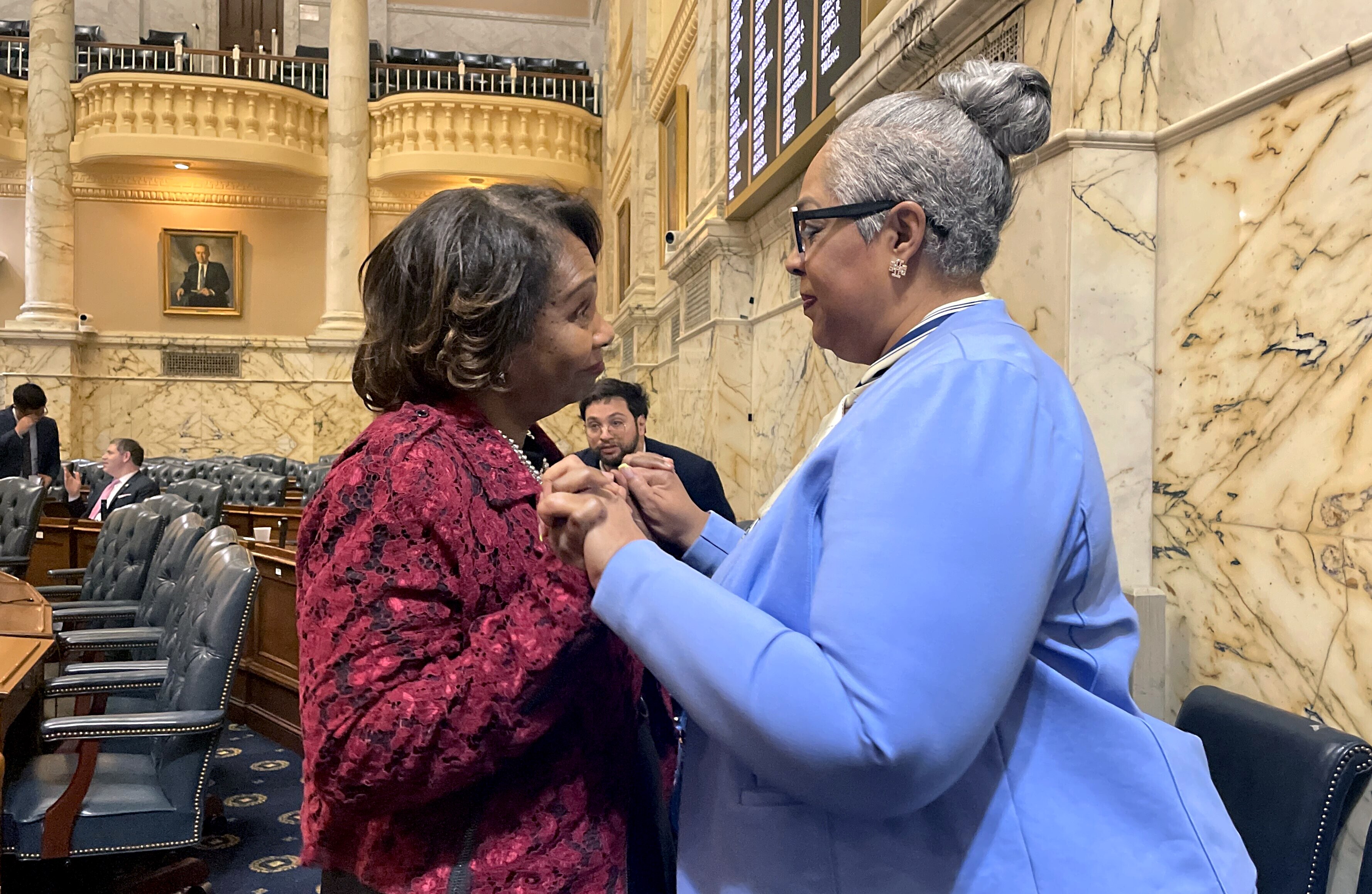 Del. Charlotte Crutchfield, left, congratulates Del. Aletheia McCaskill after the House of Delegates approved a bill creating a state commission to study reparations for slavery. McCaskill, a Baltimore County Democrat, is one of the lead sponsors of the legislation, which won final approval after an intense debate on Wednesday, April 2, 2025.