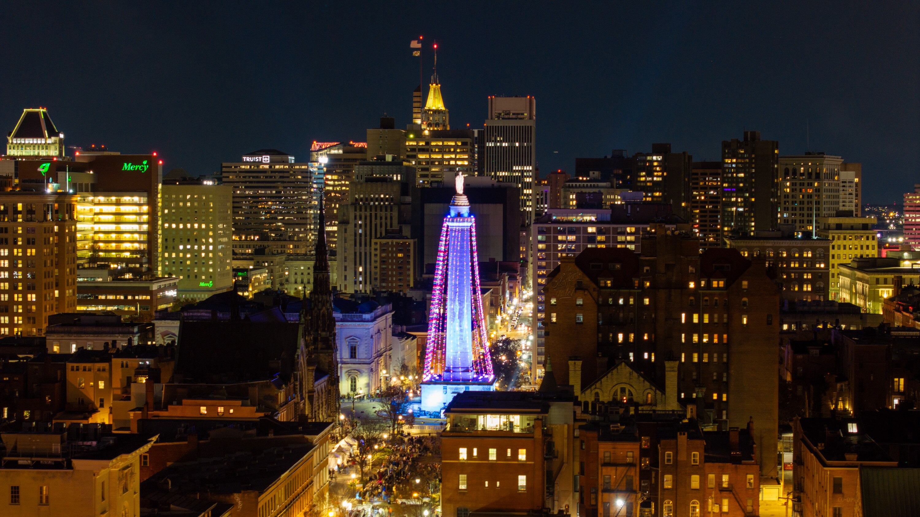 The Washington Monument is lit up for the holiday, but city officials cancelled the planned fireworks show as fire crews battle multiple fires in frigid, windy conditions.