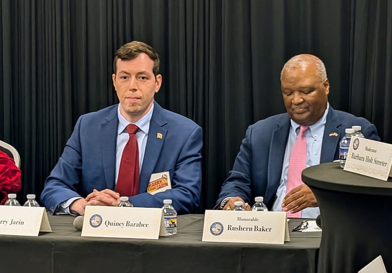 Volunteer firefighter Harry Jain, left, and former Prince George's County Executive Rushern Baker, wait their turn on May 3, 2026 to make an impression at the South County Democratic Club 5th District candidate's forum.