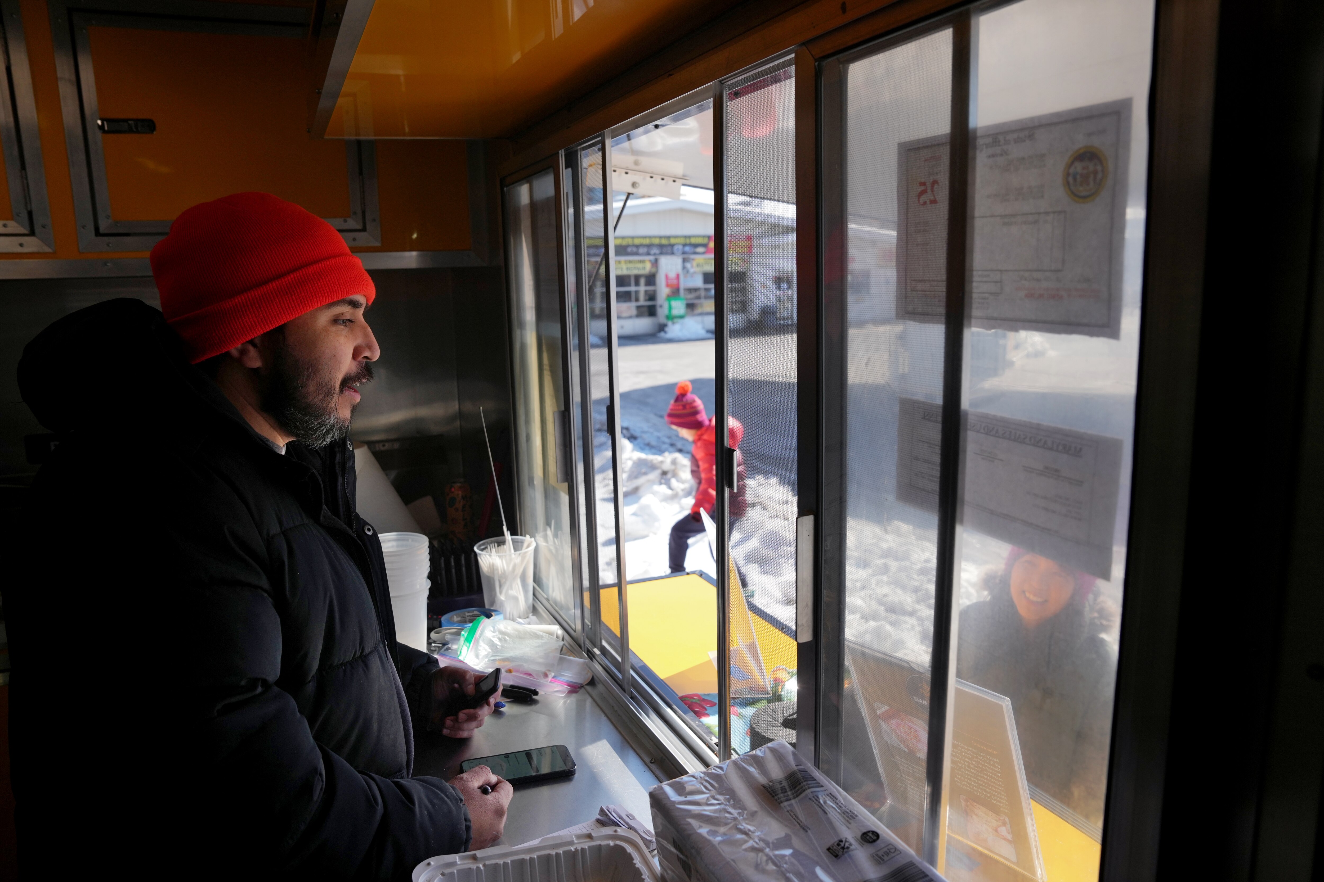 Chef Saul Zelaya chats with a customer from his food truck, Hijos del Maíz, in Rockville.