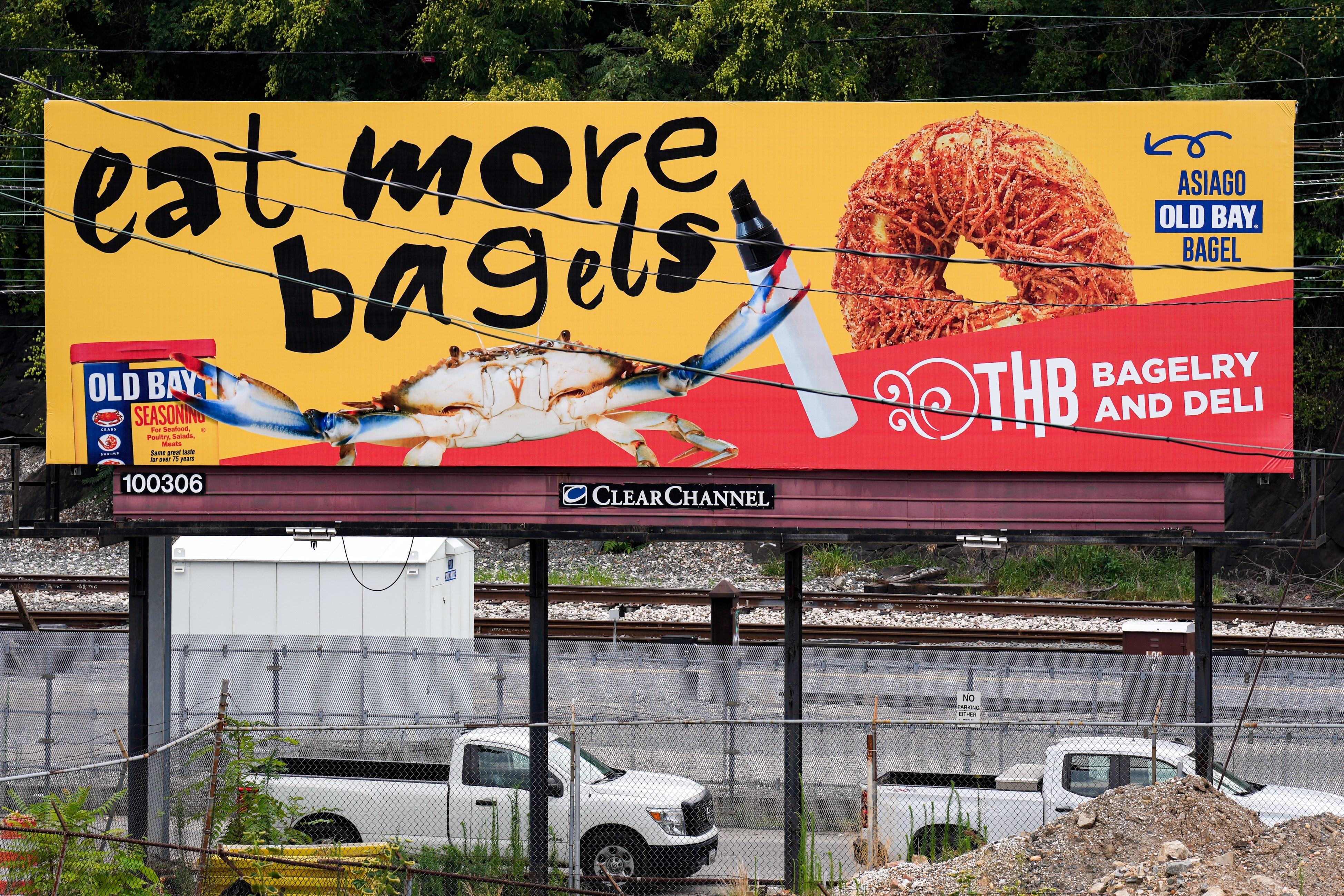 A billboard collaboration from Old Bay Seasoning and THB Bagelry and Deli is seen next to I-83 North.