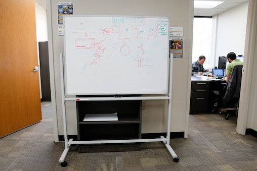 Employees have a meeting during a tour of the office where engineers work on the design for the new Francis Scott Key Bridge project, located in an Anne Arundel County business park, on Tuesday, December 16, 2025.