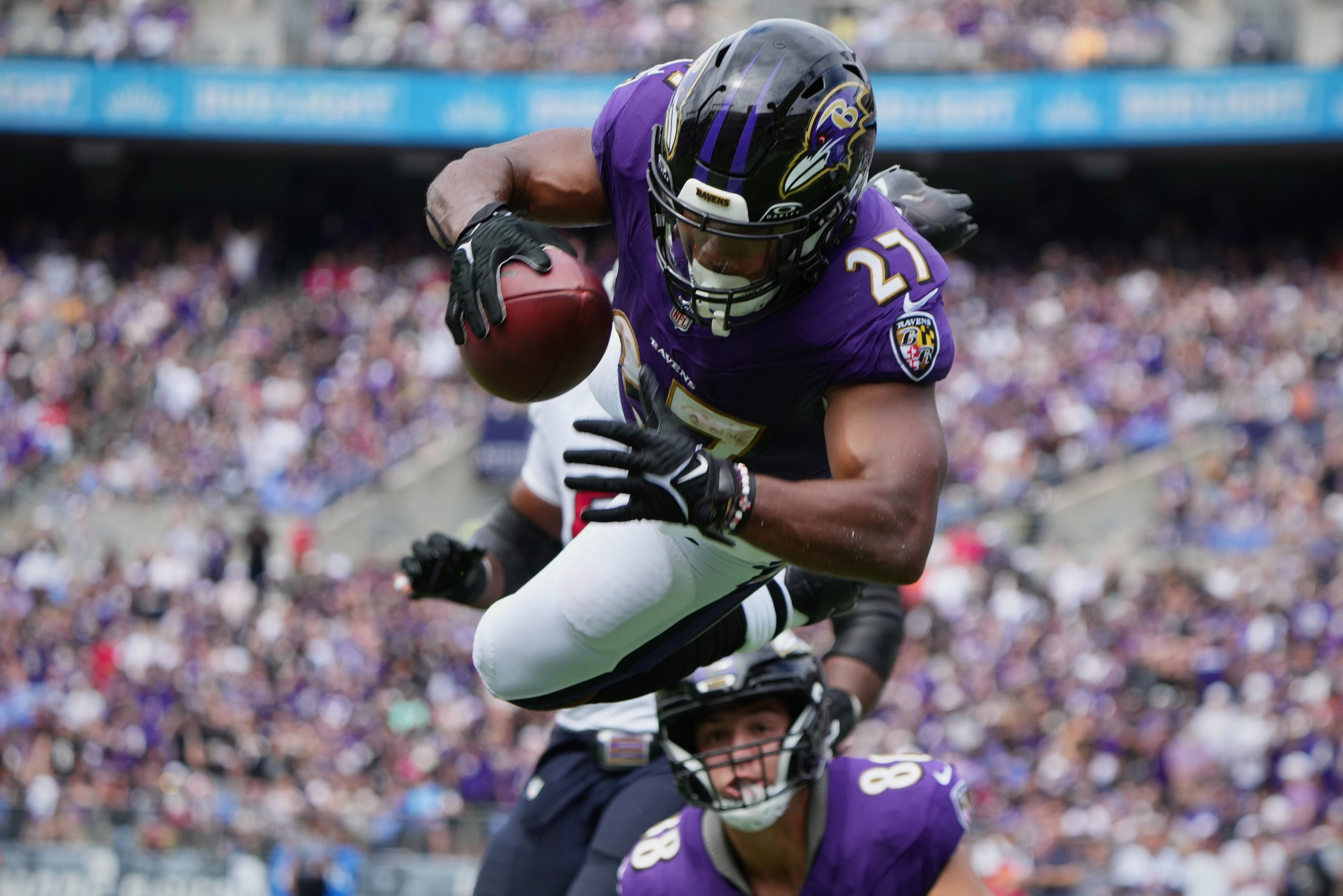 JK Dobbins goes airborne to score a TD in the first quarter of the Ravens game against the Houston Texans at M&T Bank Stadium.