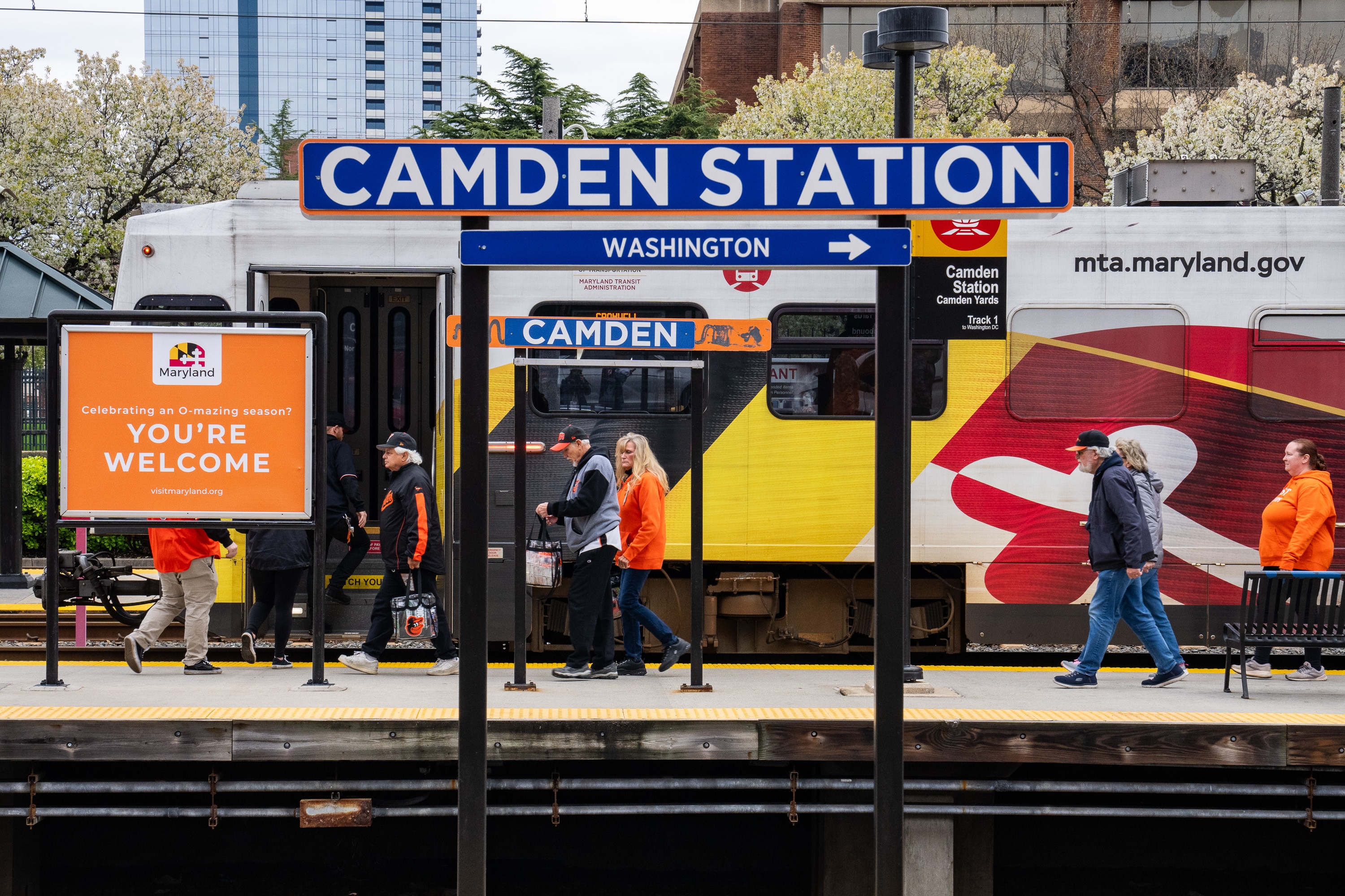Orioles fans walk off the light rail at Camden Station ahead of the game on opening day, March 28, 2024.