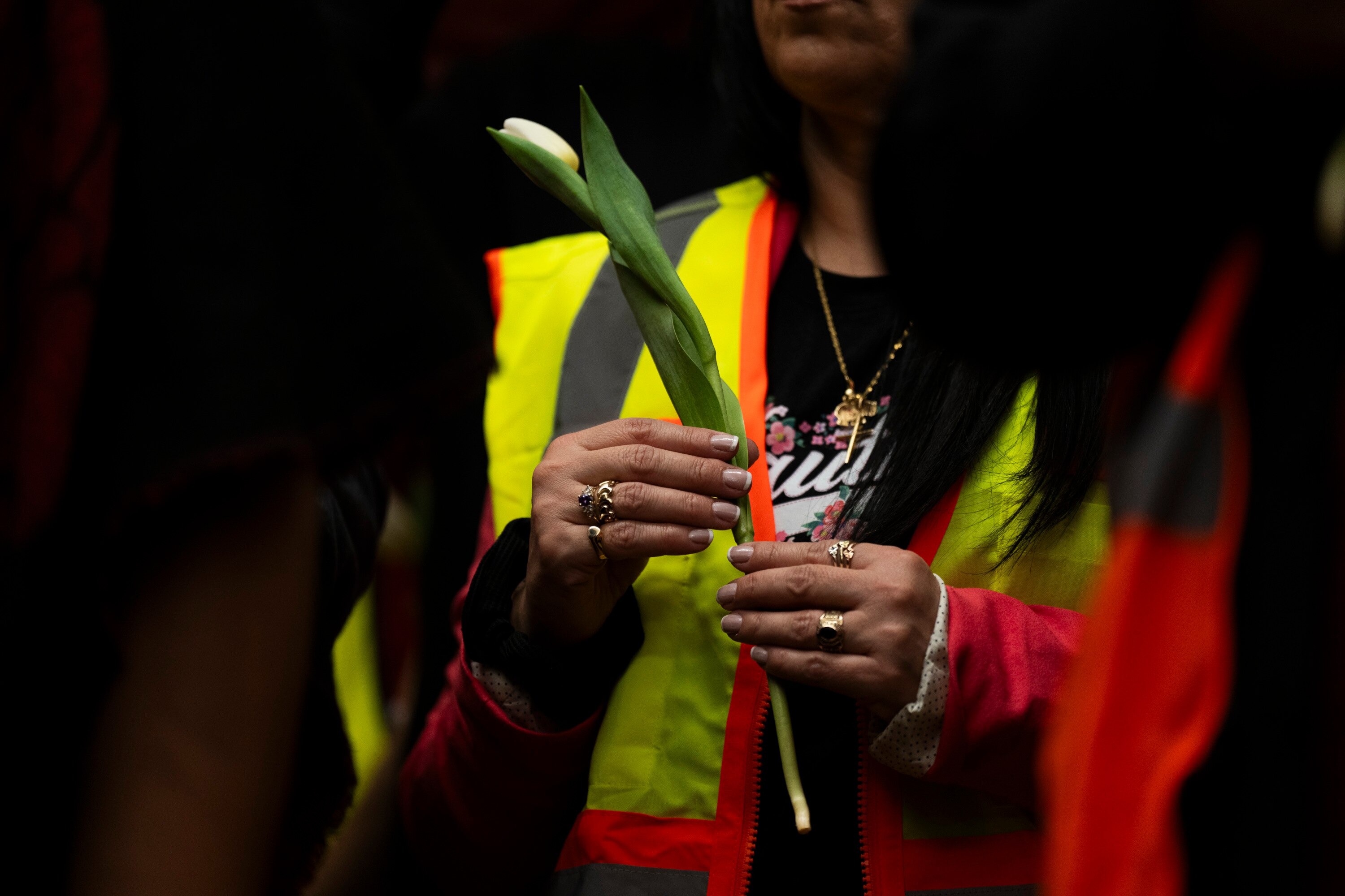 Construction workers honored the Key Bridge victims during a press conference on March 28, 2024 at CASA’s Baltimore worker center. They held white lilies and raised their hands in solidarity.