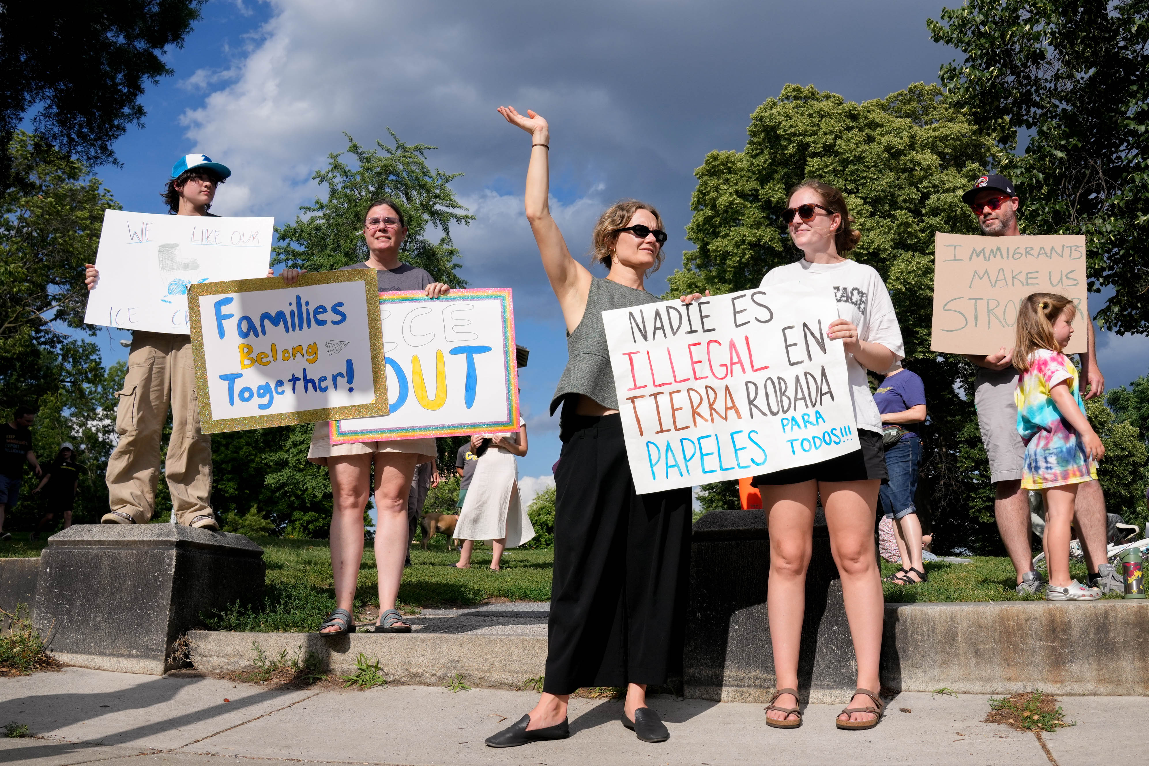 Parents and community members rally at Patterson Park on Friday evening after ICE detained parents outside a school Thursday.