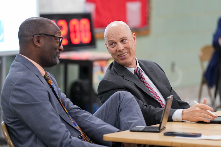 Dr. Mark Bedell (left), Anne Arundel County Schools Superintendent, and AACPS Chief Operating Officer William “Bill” Heiser listen to public comment about proposed school redistricting plans during a meeting at Annapolis Middle School in Annapolis, Md. on Tuesday, April 29, 2025.