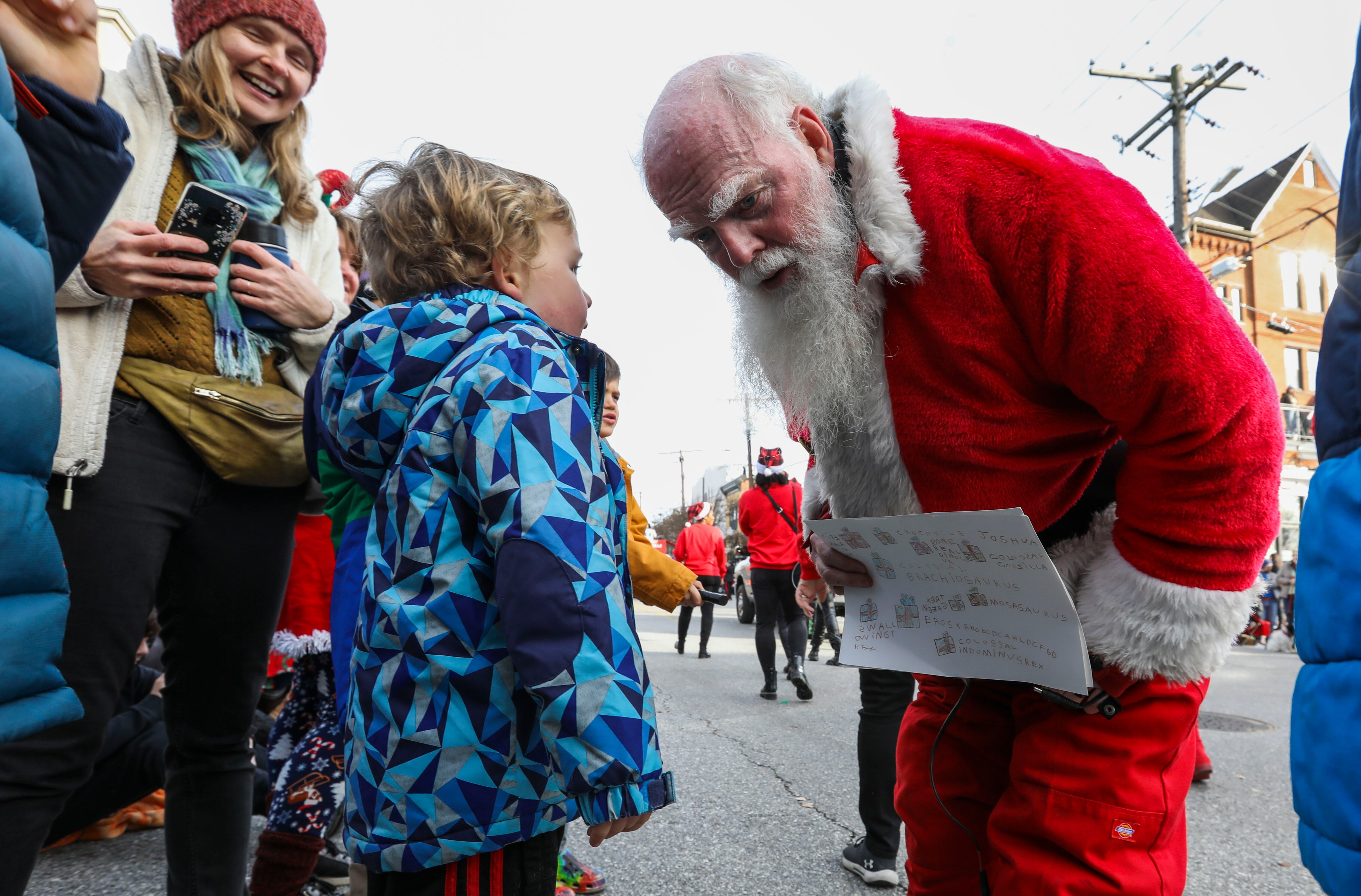 Santa Kevin asks Leo Phair, 5, want he wants for Christmas at Hampden's Annual Holiday Parade on December 4, 2022.
