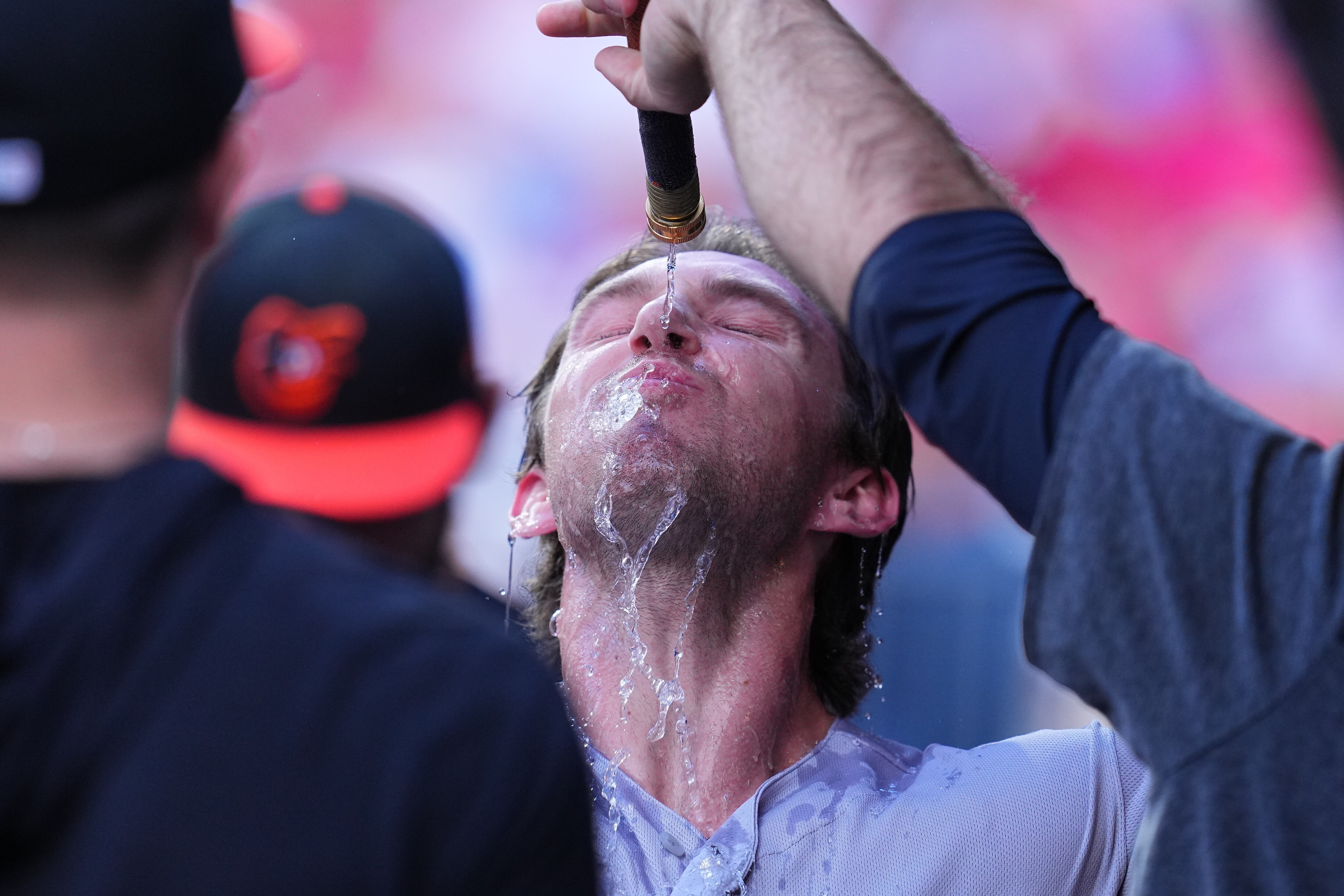 Jordan Westburg #11 of the Baltimore Orioles has water poured on him in the dugout after hitting a solo home run in the top of the second inning against the Philadelphia Phillies at Citizens Bank Park on July 24, 2023, in Philadelphia.